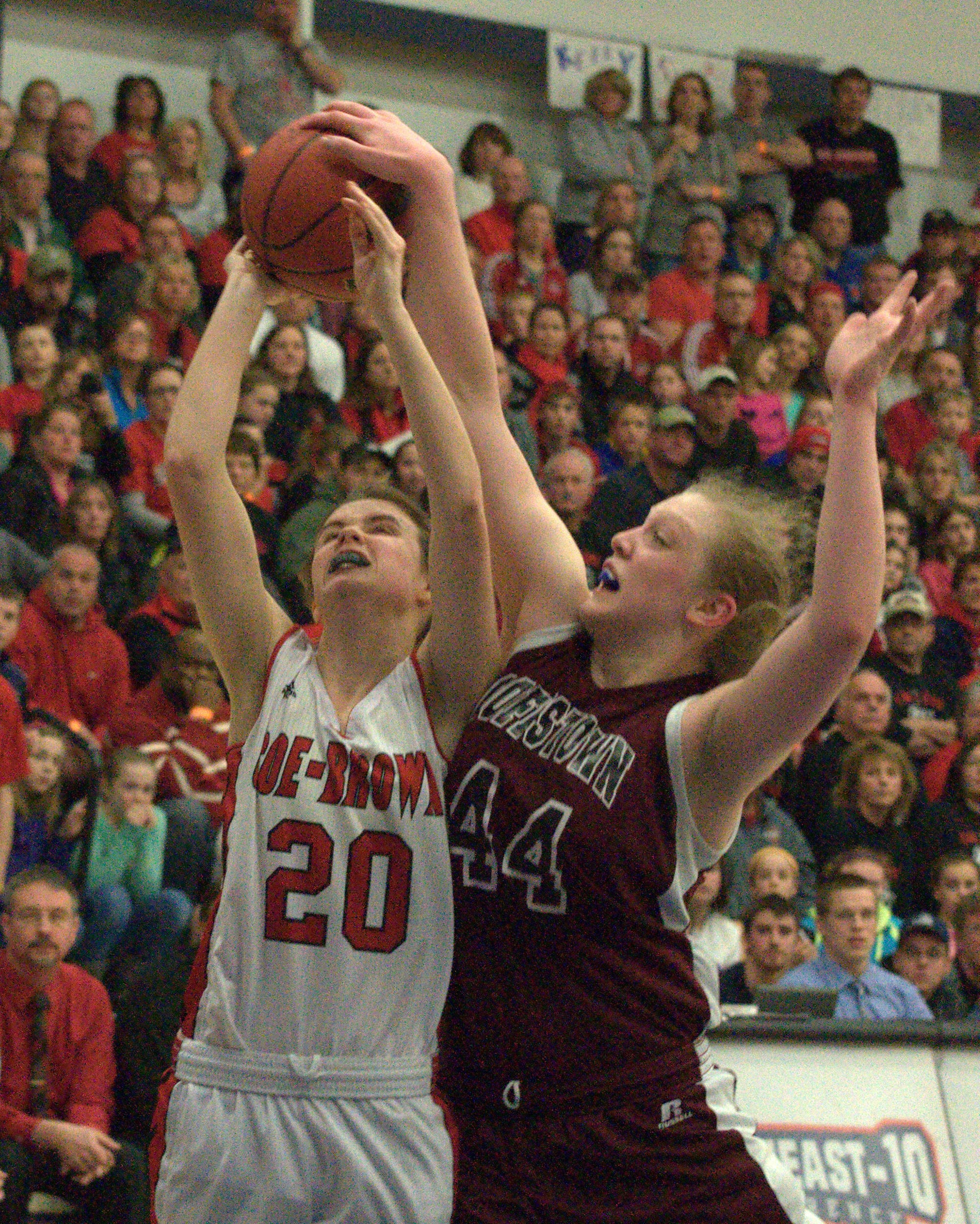 Goffstown's Rene Roggenbuck blocks a shot by Coe-Brown's Sarah Curtin. For more photos, go to the Photo Album.