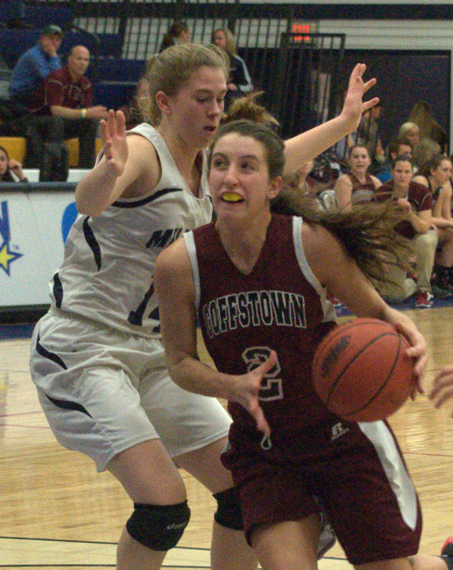 Goffstown's Hannah Larochelle drives to the basket past Milford's Jess Ryan.