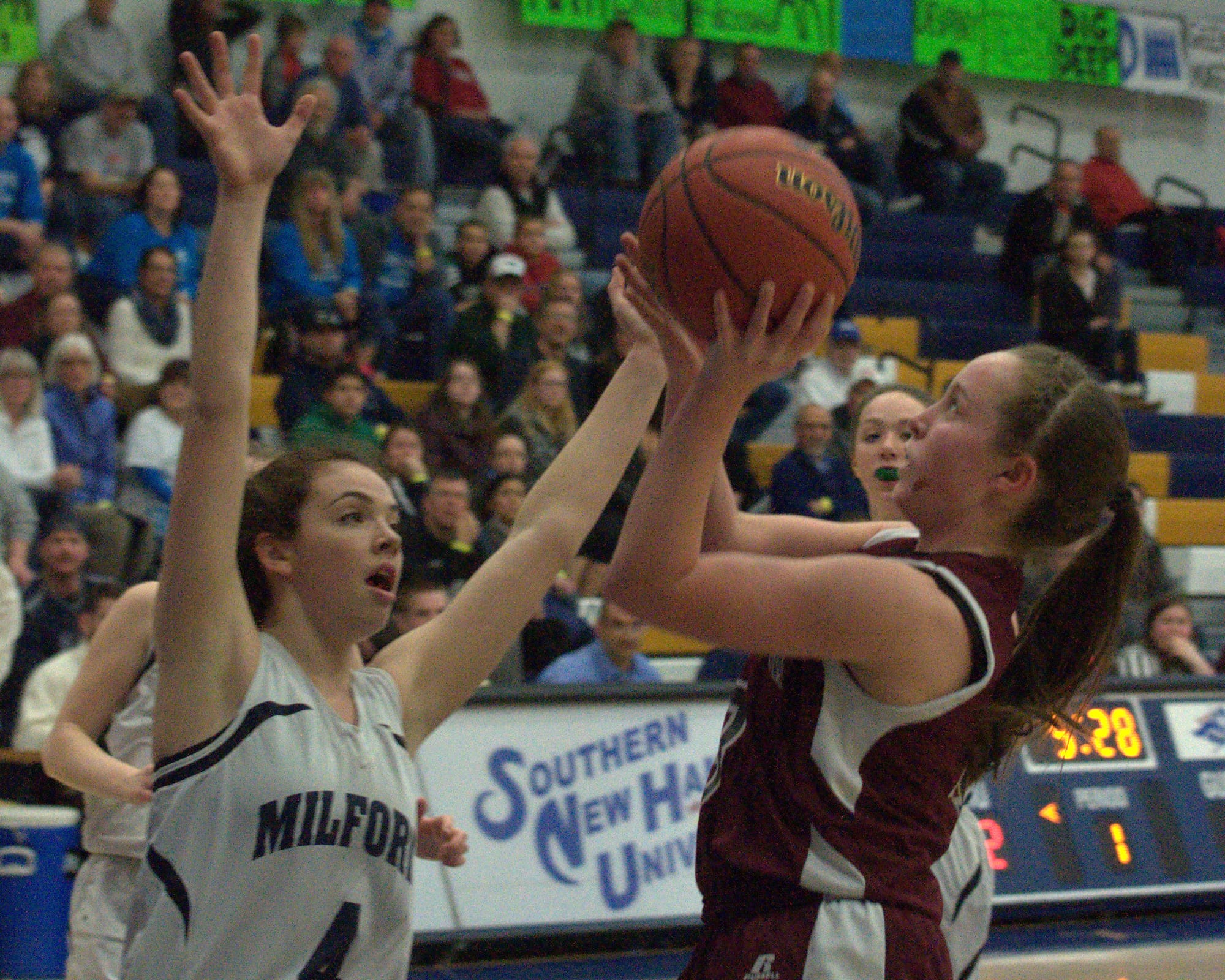 Goffstown's Sarah Doherty takes a shot as Milford's Adelle Pitsas defends during Thursday's semifinal. For more photos, go to the Photo Album.