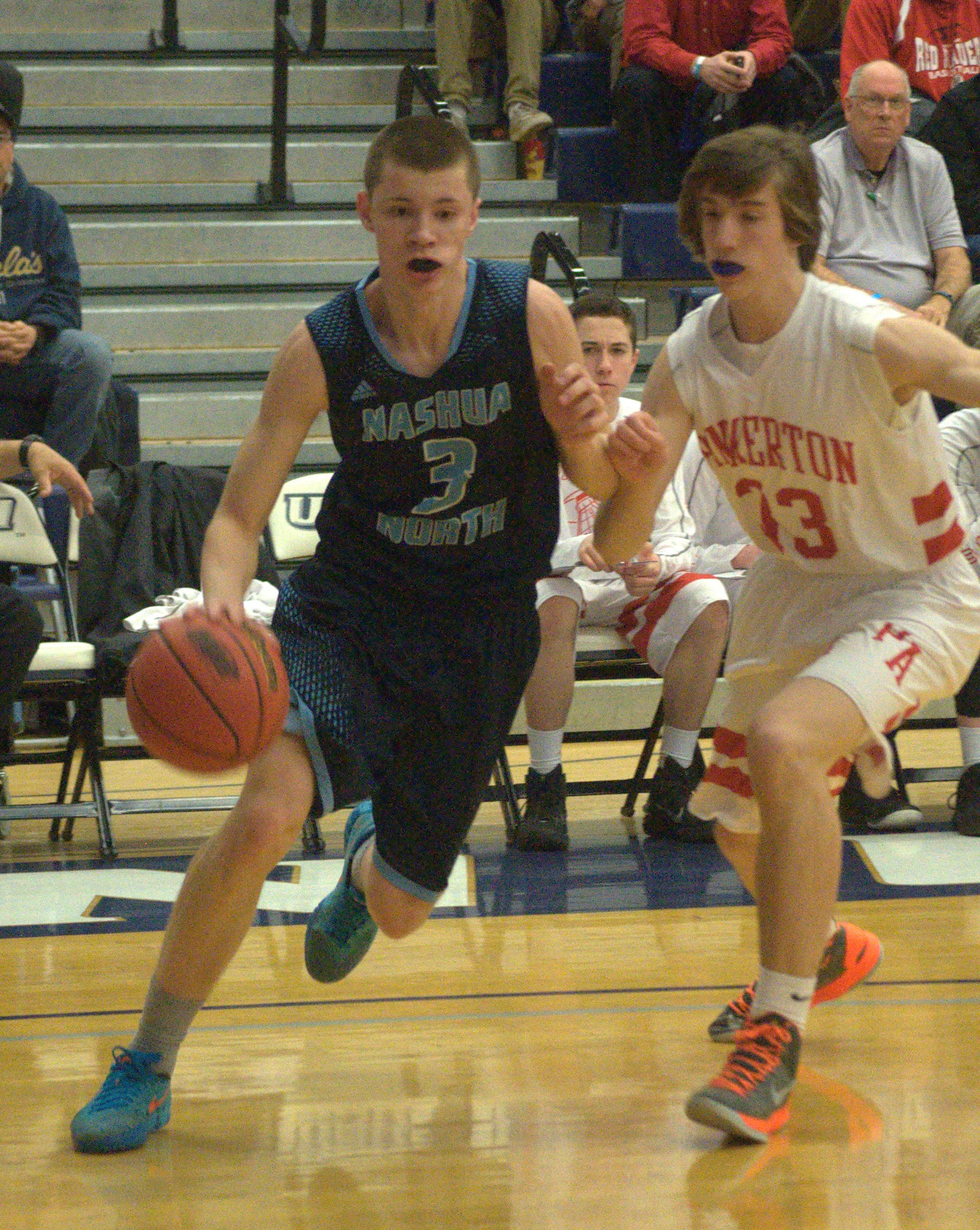 Nashua North's Nathan Hale drives to the basket against Pinkerton's Brennan Morris.