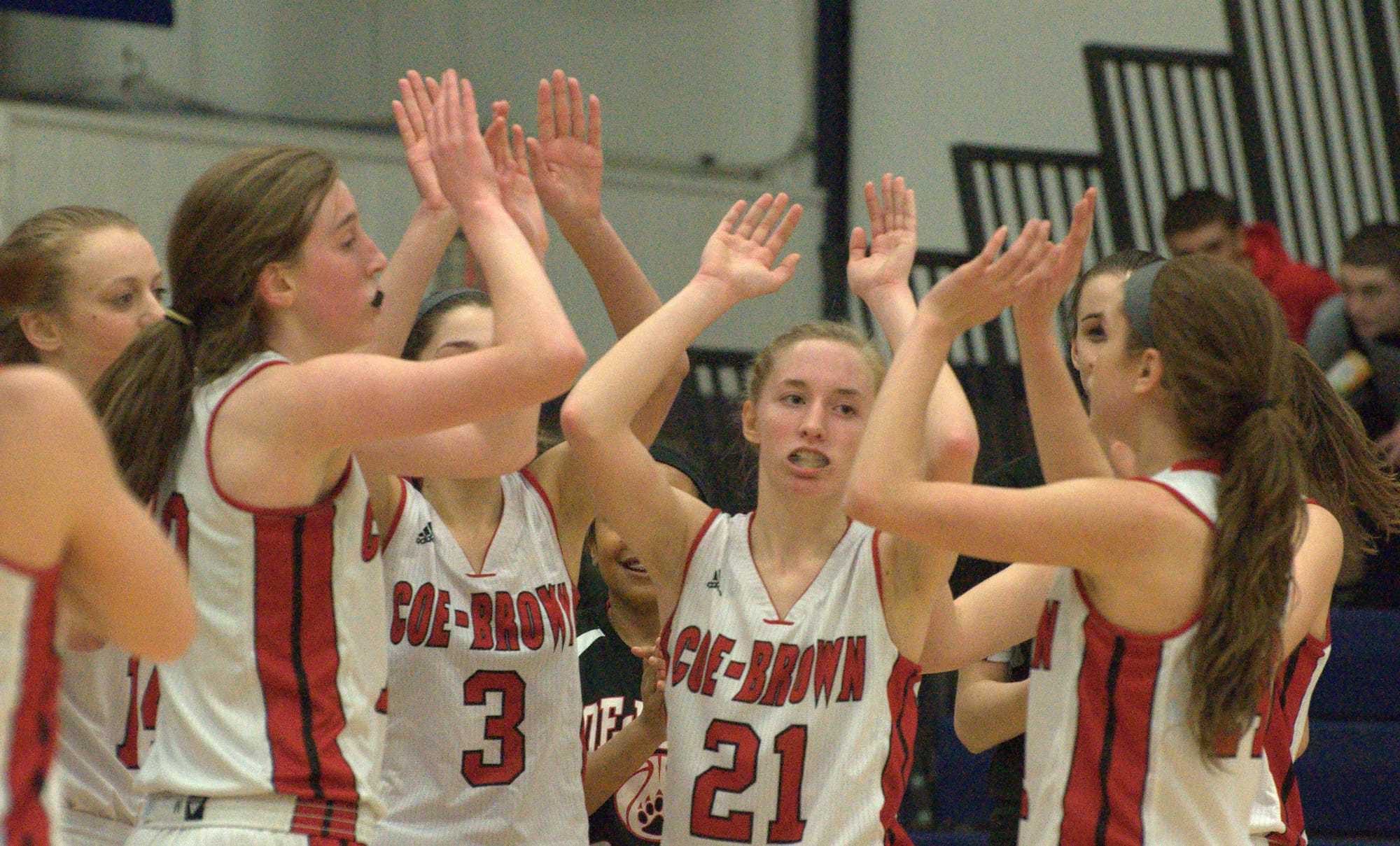 The Coe-Brown girls basketball team celebrates after Thursday's semifinal win over Pembroke. For more photos, go to the Photo Album.