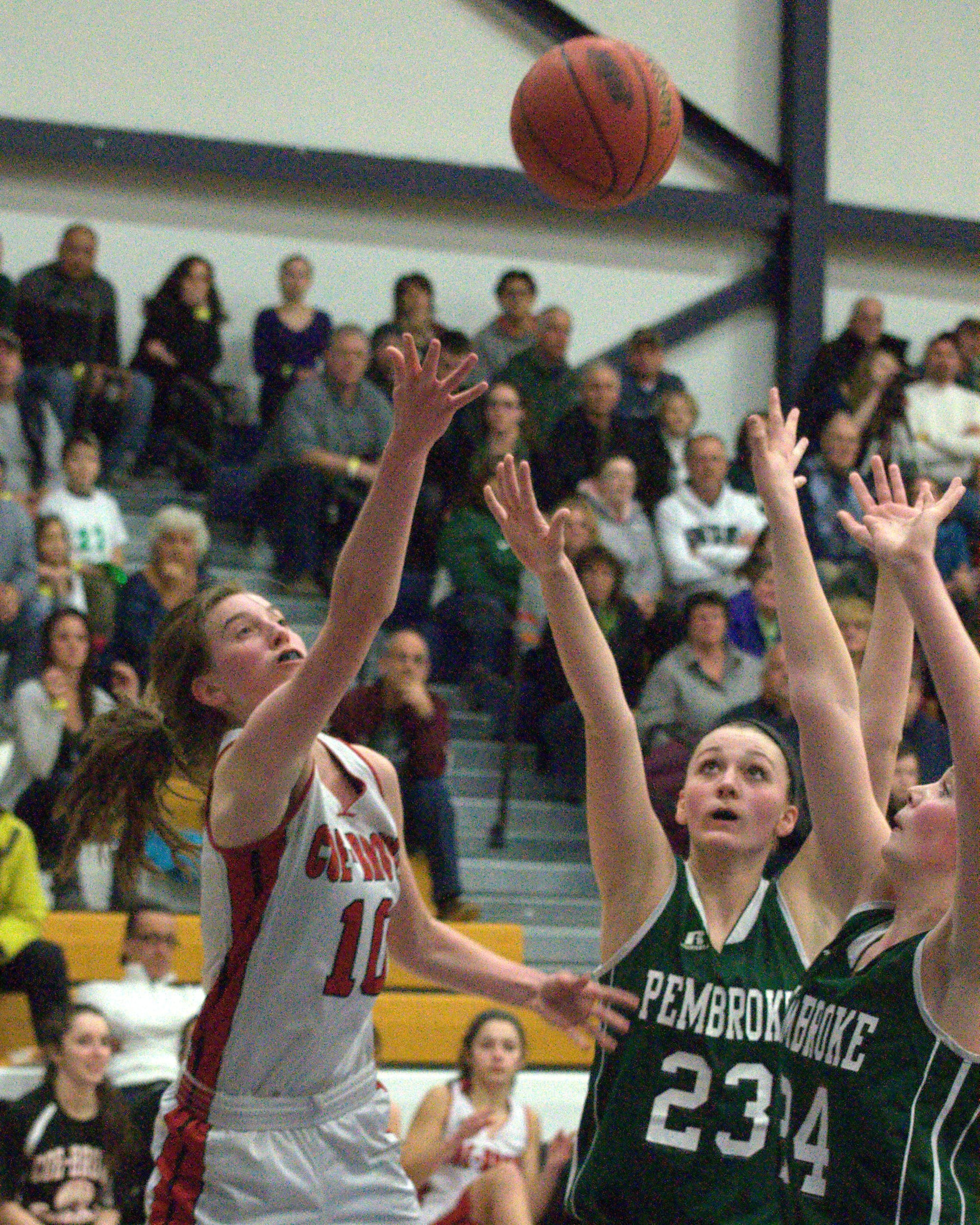 Coe-Brown's Jennifer Schlim puts up a shot as Pembroke's Karli Loiselle, left, and Morgan Allen defend.