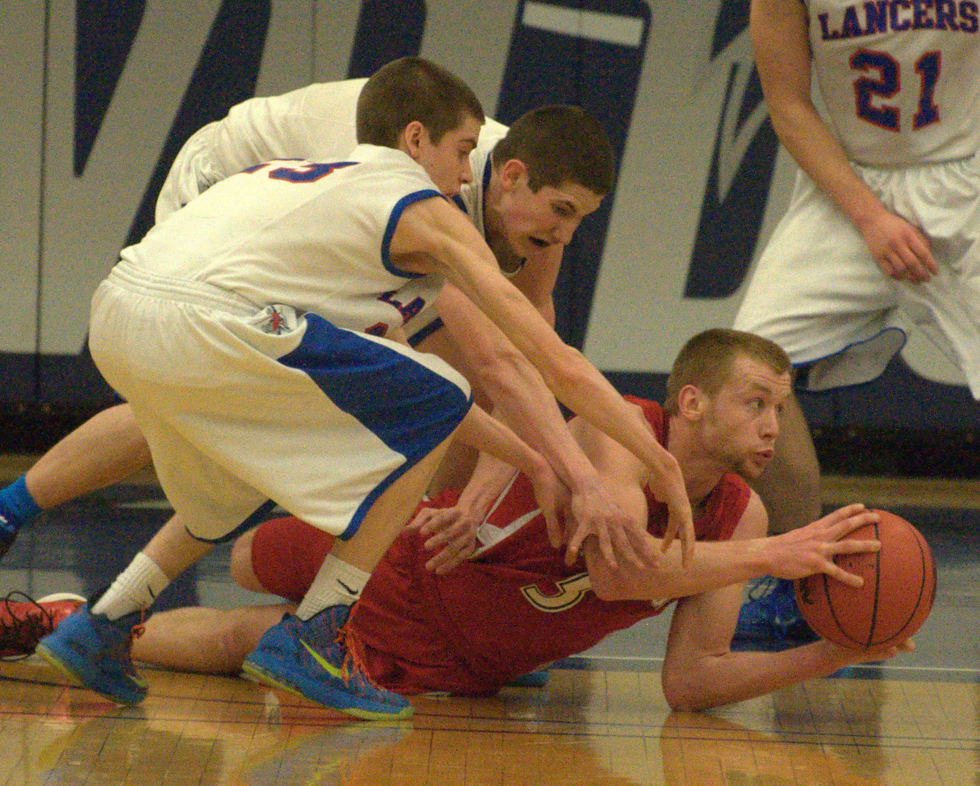 Spaulding's Darian Berry tries to get rid of the ball as Londonderry's Jacob Coleman, left, and Cody Ball reach for it during Tuesday's game.