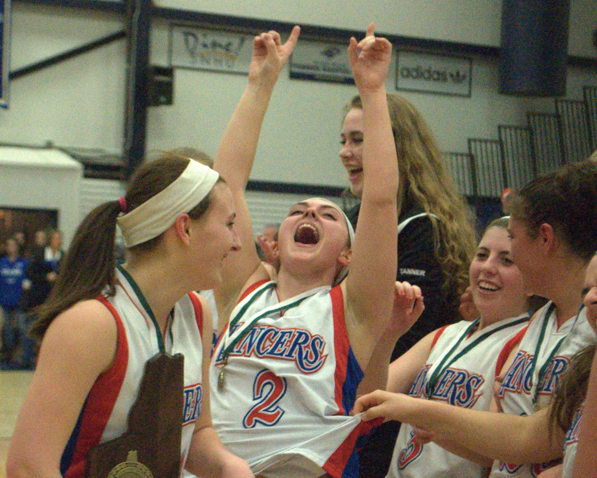 Londonderry's Katherine Wells, center, celebrates with her teammates Friday after the Lancers defeated Winnacunnet to win the Division I championship.