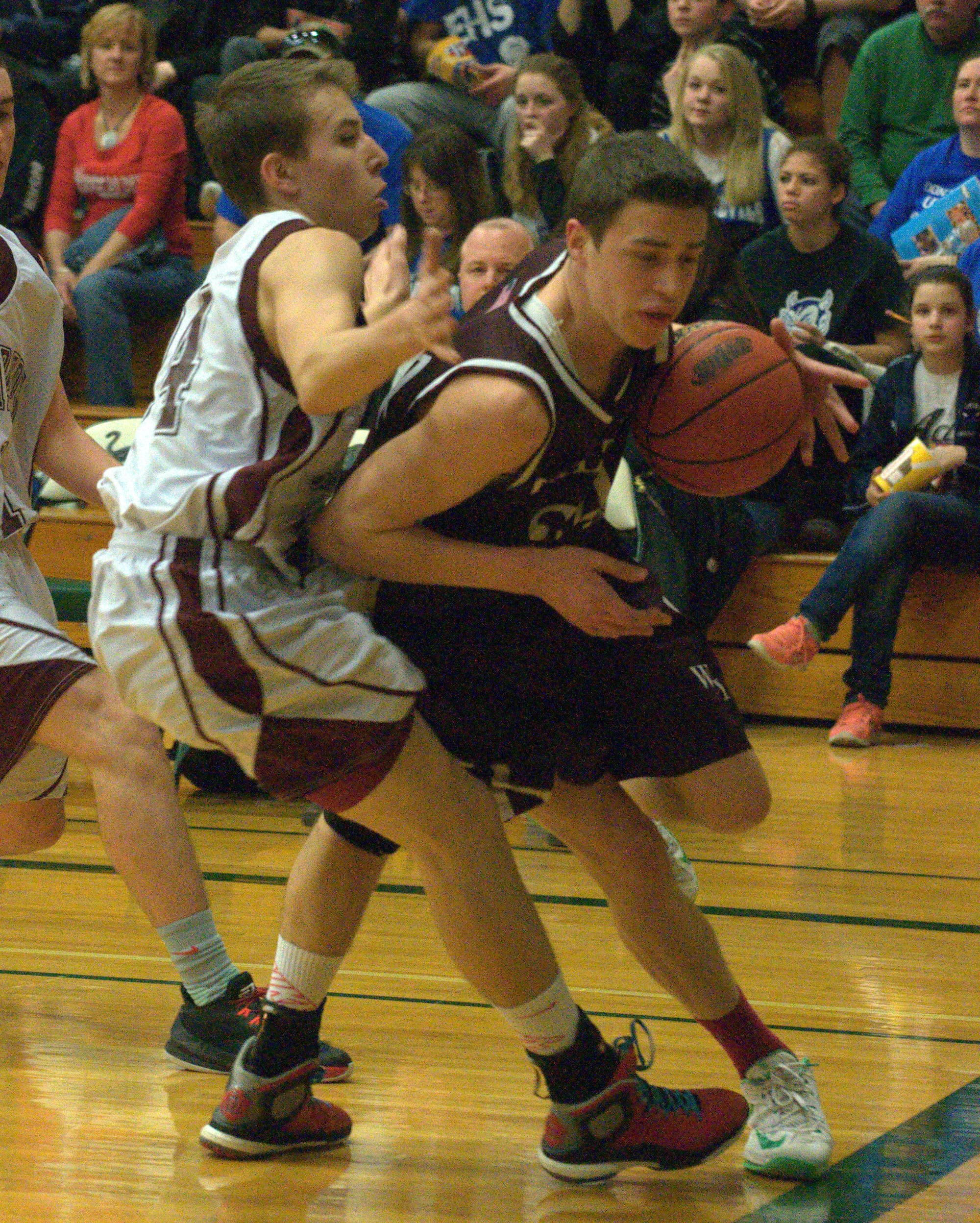 Wilton-Lyndeborough's Trey Carrier is fouled by Littleton's Kuba Kubkowski as he drives the baseline Monday.
