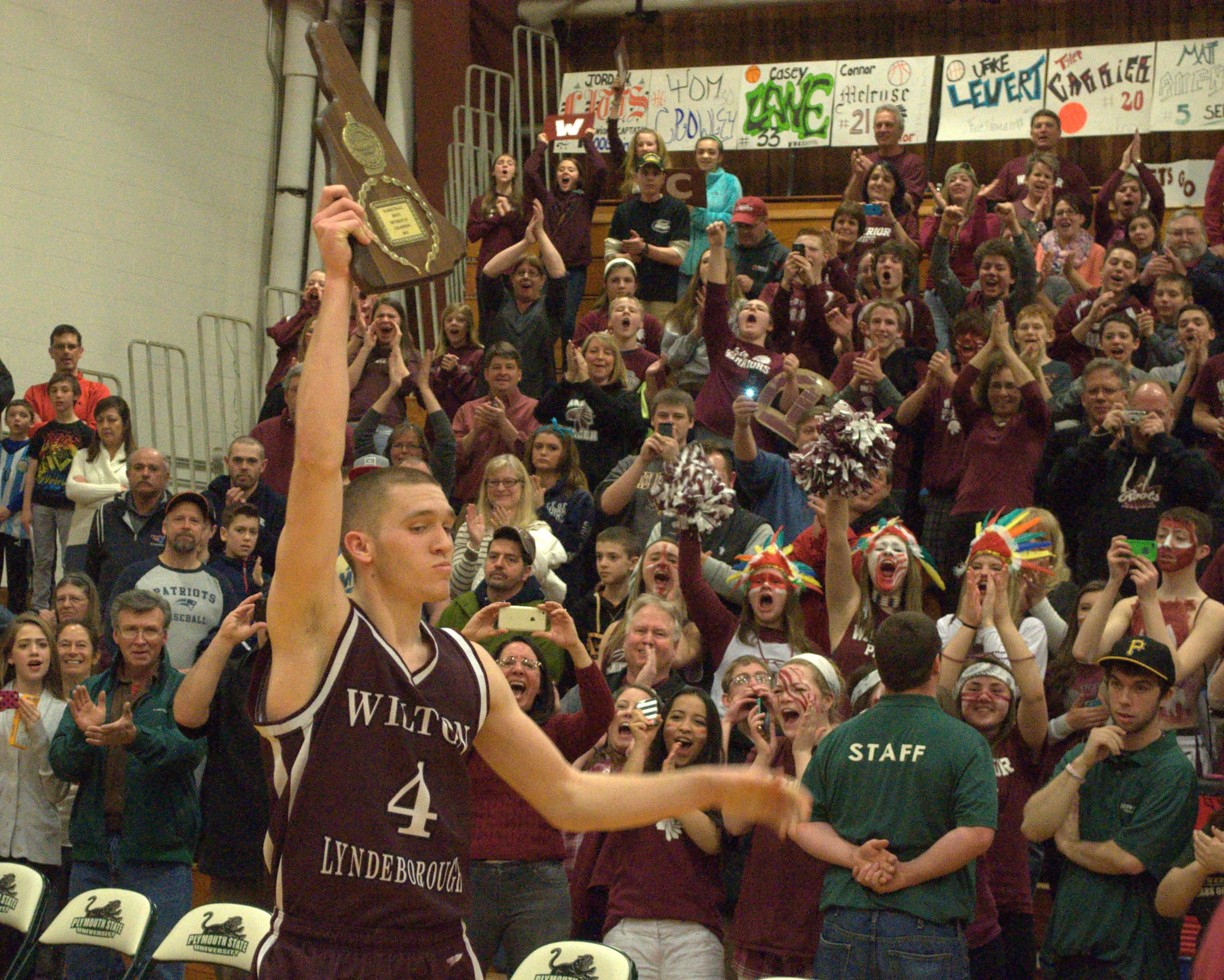 Wilton-Lyndeborough's Jordan Litts holds up the Division IV championship plaque. For more photos, go to the Photo Album.