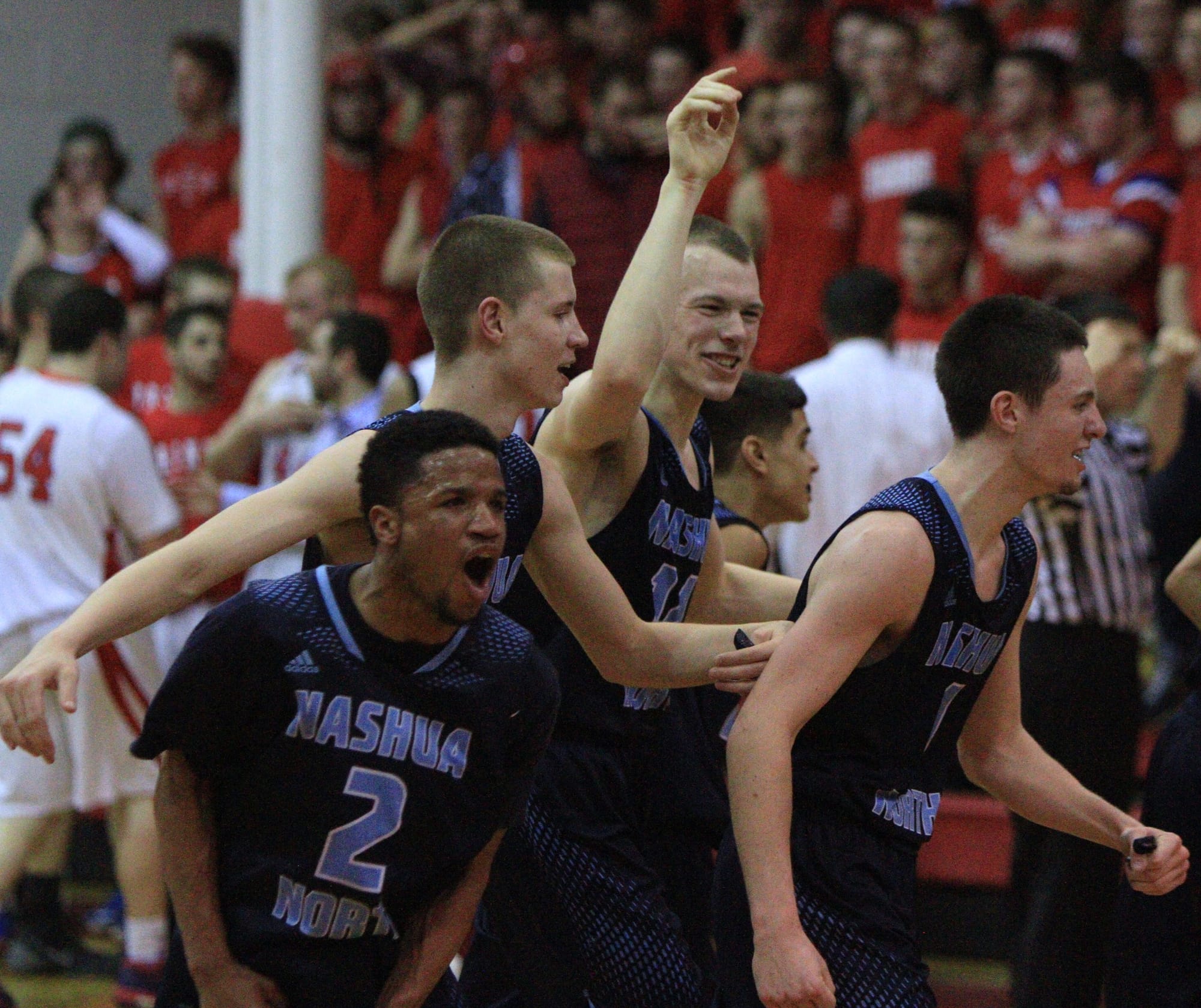 Brendan Barrett leads a group of happy Titans to the bench during a second quarter timeout in Saturday night's Division I quarterfinal at Trinity. From left, Alejandro Jones, Nathan Hale, Brennan Kastens are celebrating a Barrett 3-pointer (Courtesy photo).