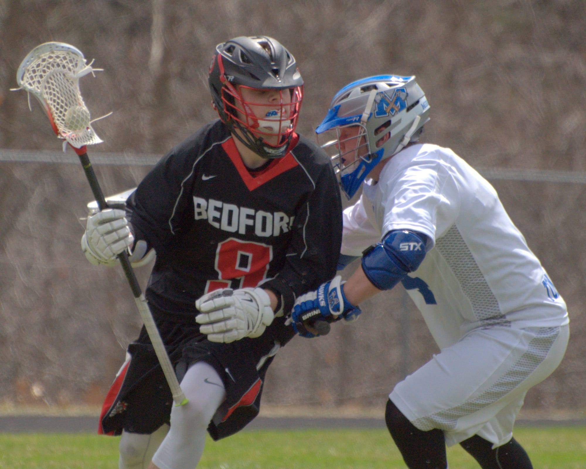 Bedford's Dakota Clark makes a move to get by Merrimack's Avery Paulson during Saturday's game.