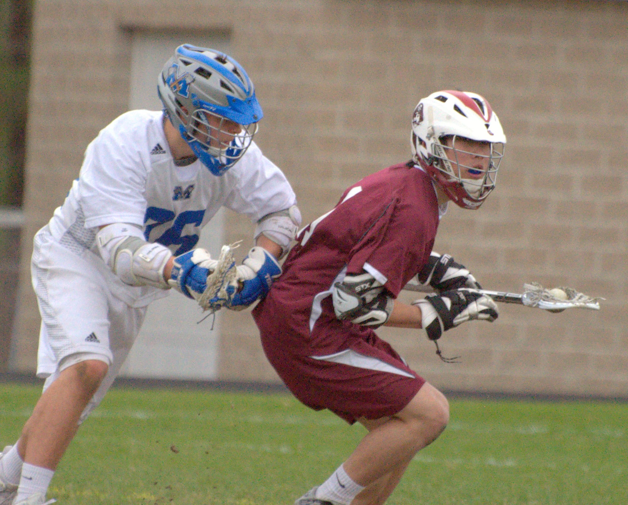 Hanover's Kaz Matsuoka looks down field after winning a faceoff against Merrimack's Matt Brewster.
