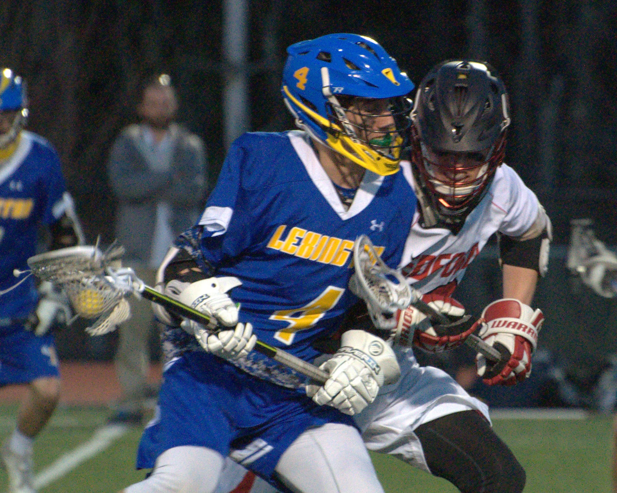 Bedford's Duncan Kirkpatrick tries to slow down Lexington's Alex Lenrow.