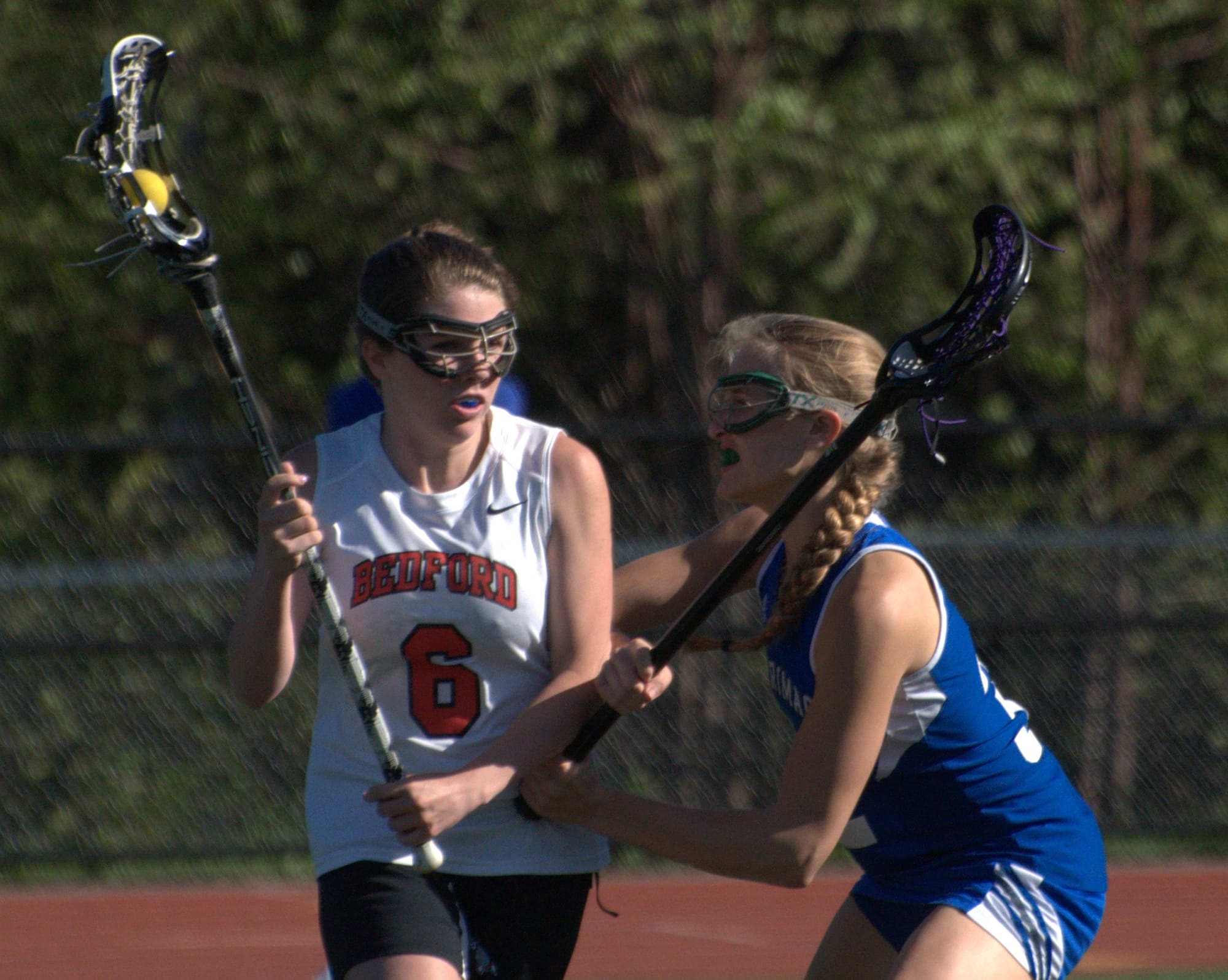 Bedford's Kathryn Lesch tries to get around Merrimack's Charlotte Perry during Wednesday's game.