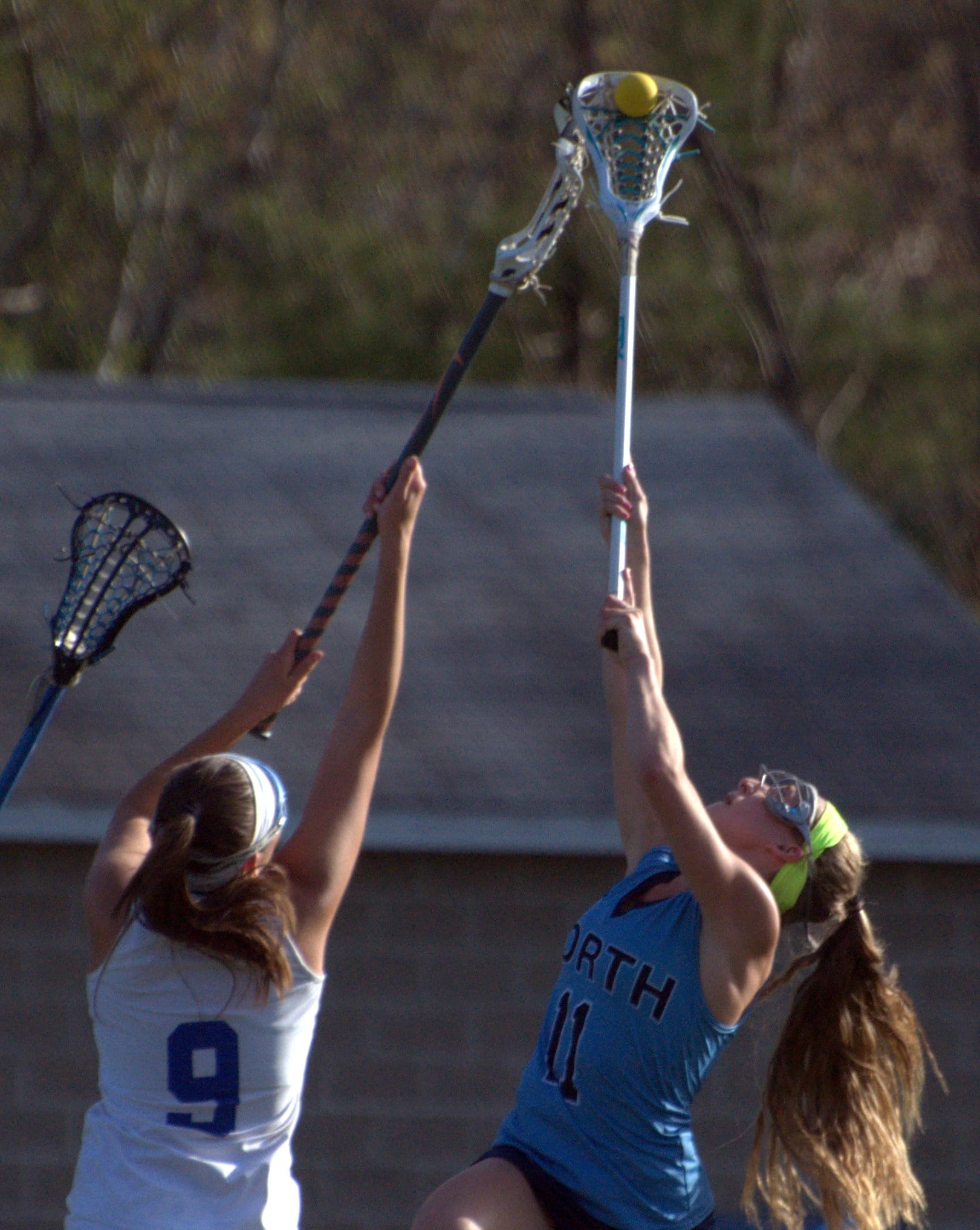 Merrimack's Samantha Aderron and Gabby Masseur fight for the draw during Wednesday's game.