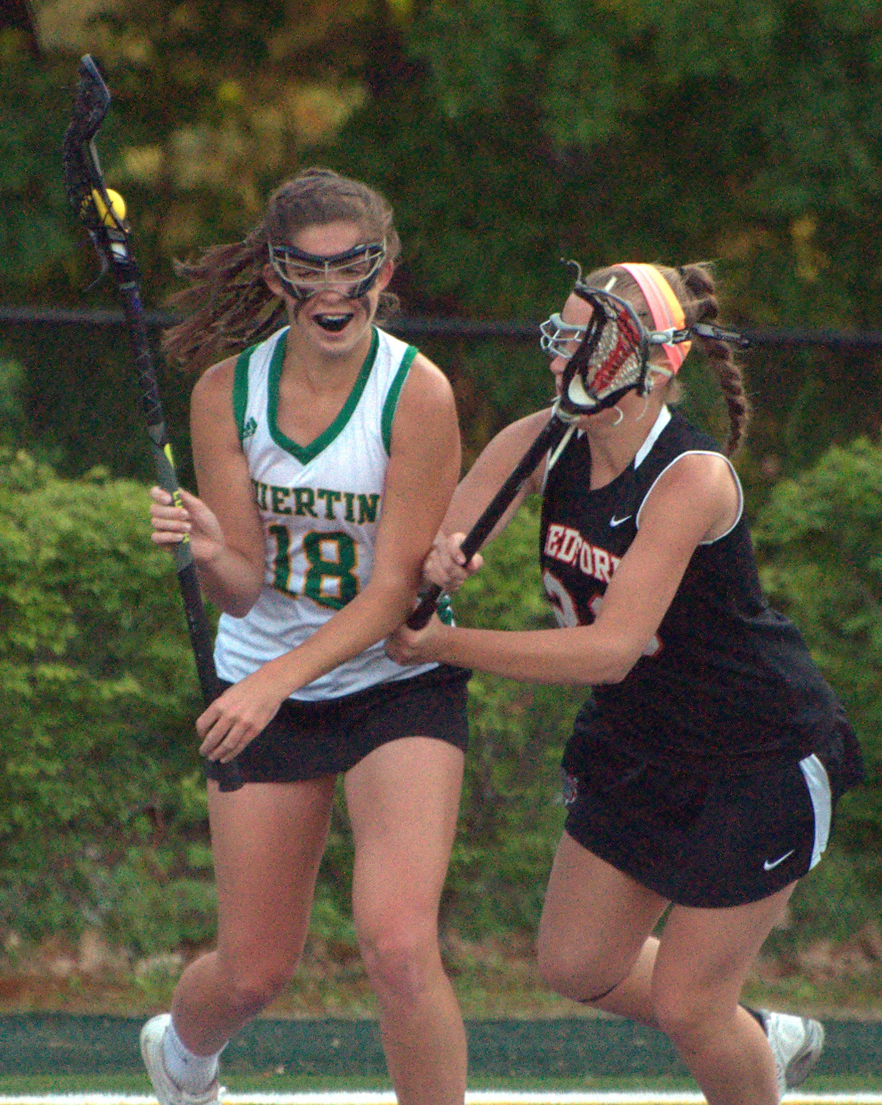 Bedford's Brooke Burdon tries to slow down Bishop Guertin's Bryn Carroll.