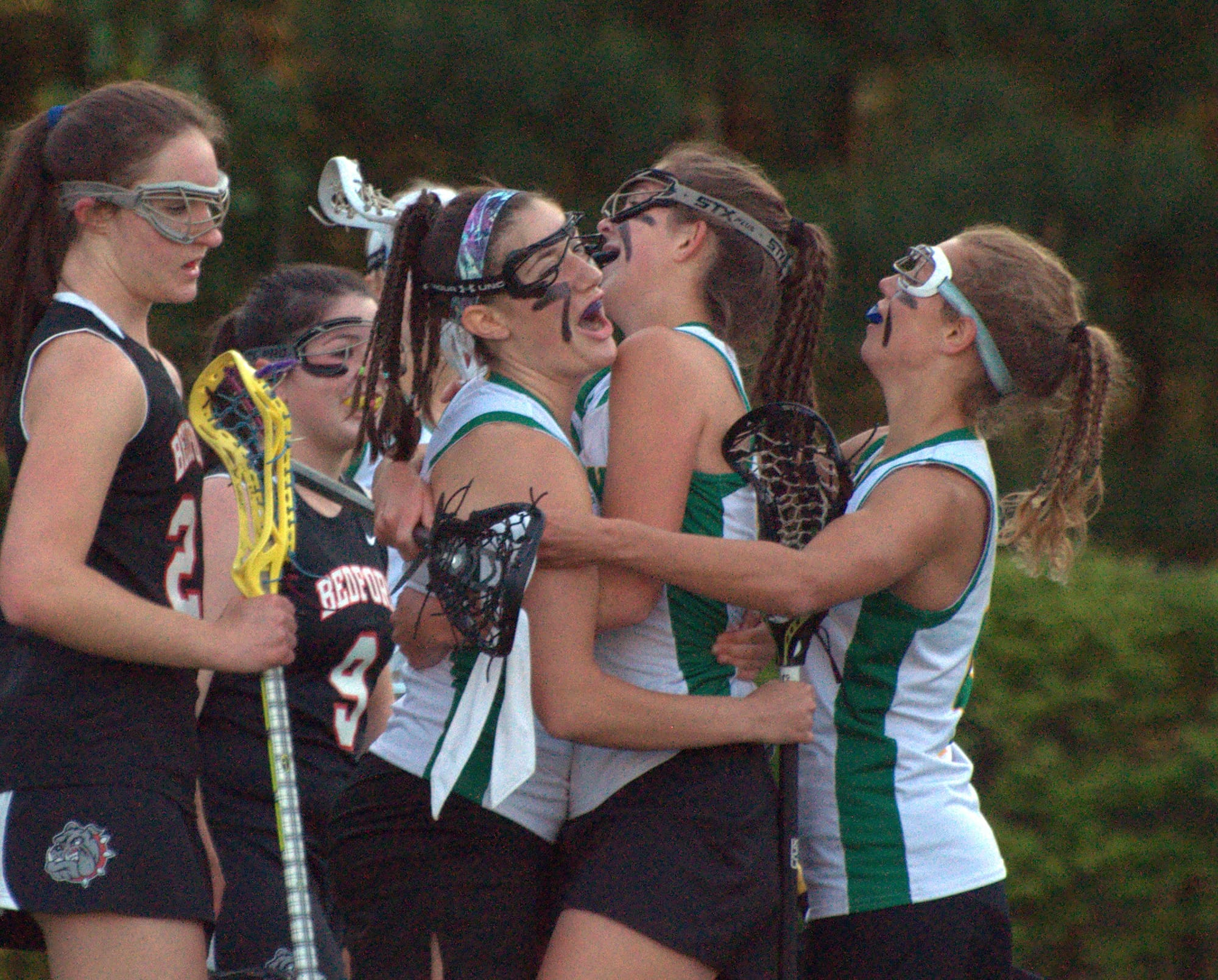 Bishop Guertin players celebrate after a goal against Bedford in the Division I quarterfinals.