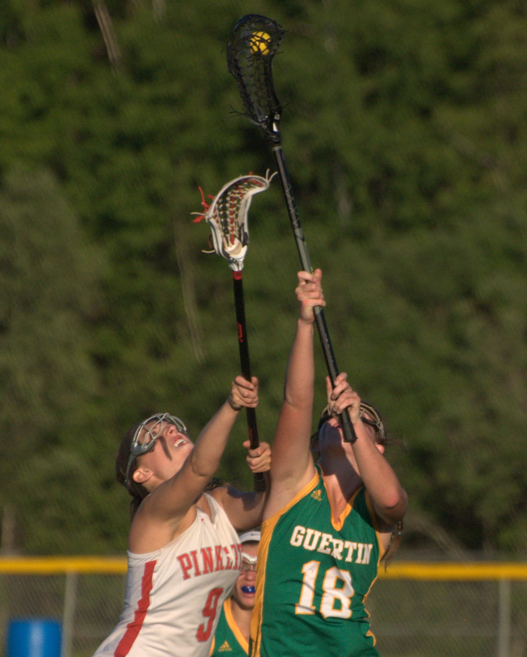 Bishop Guertin's Bryn Carroll wins the draw over Pinkerton's Megan Jarvis during Saturday's Division I semifinal.