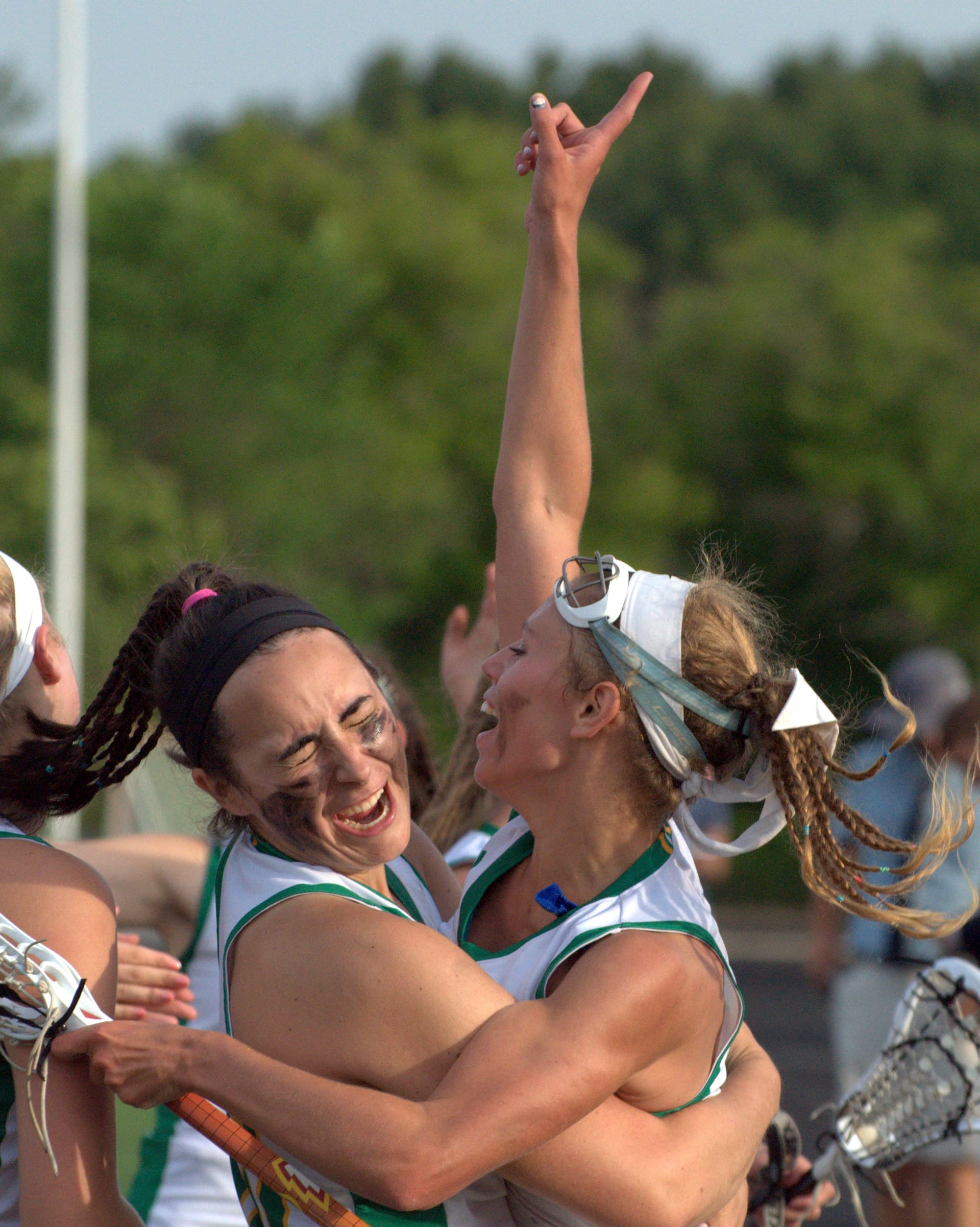 Bishop Guertin's Caitlin Scire, left, and Caroline Boudreau celebrate after the Cardinals beat Exeter in the Division I championship game.