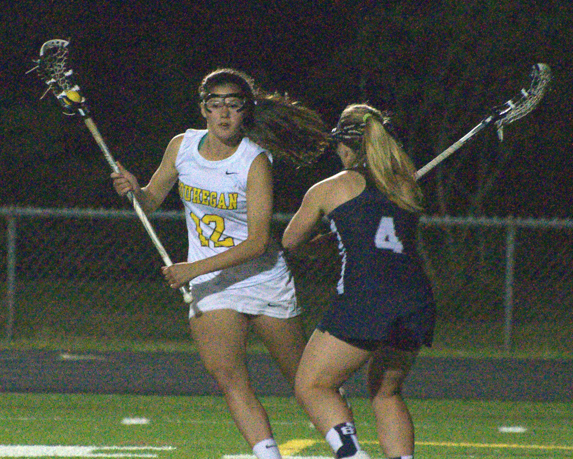 Souhegan's Emma Estabrook tries to get around Exeter's Anna Vogt during Saturday's Division I semifinal.
