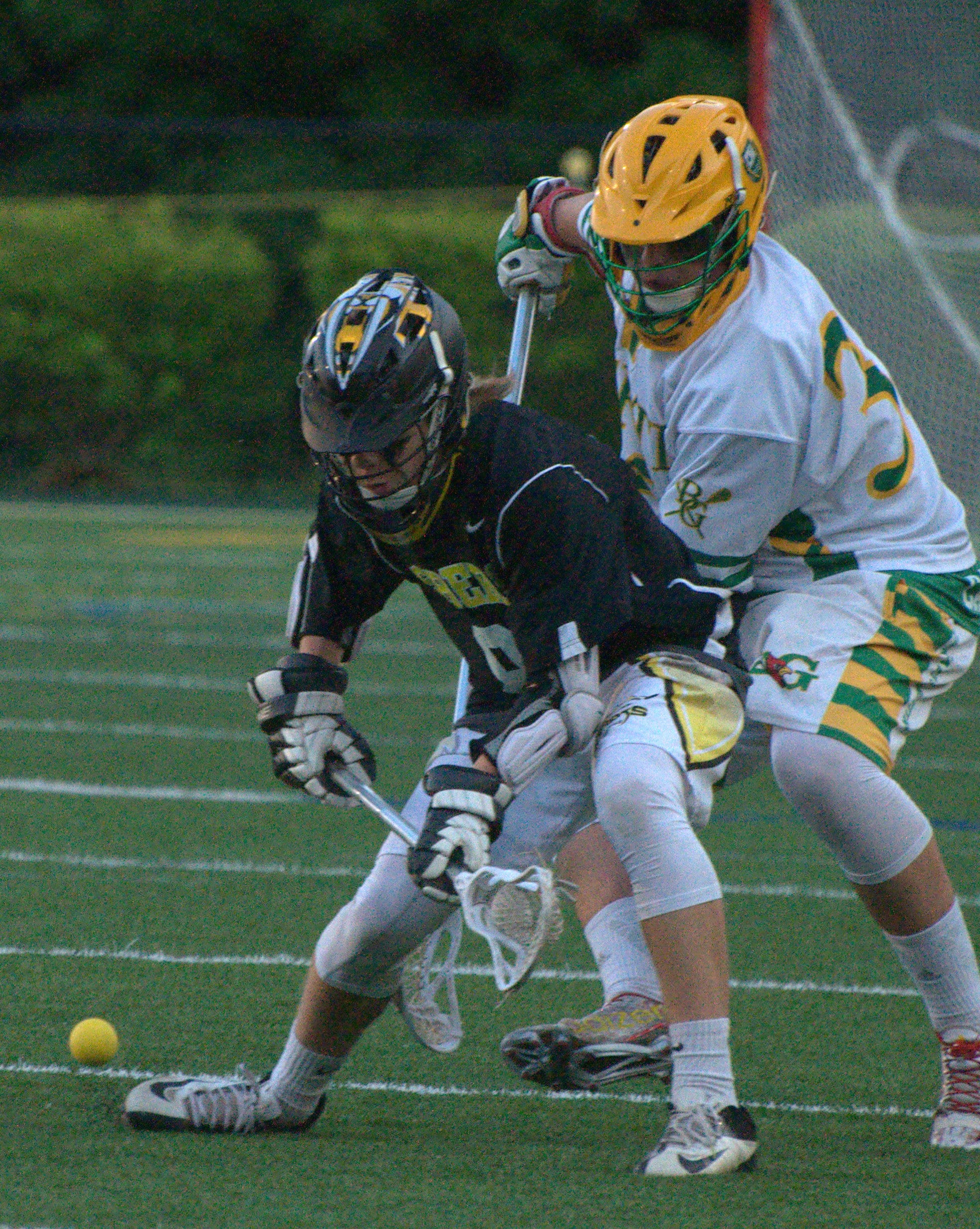Souhegan's Robert Duarte and Bishop Guertin's Christopher Lyskawa fight for a ground ball.