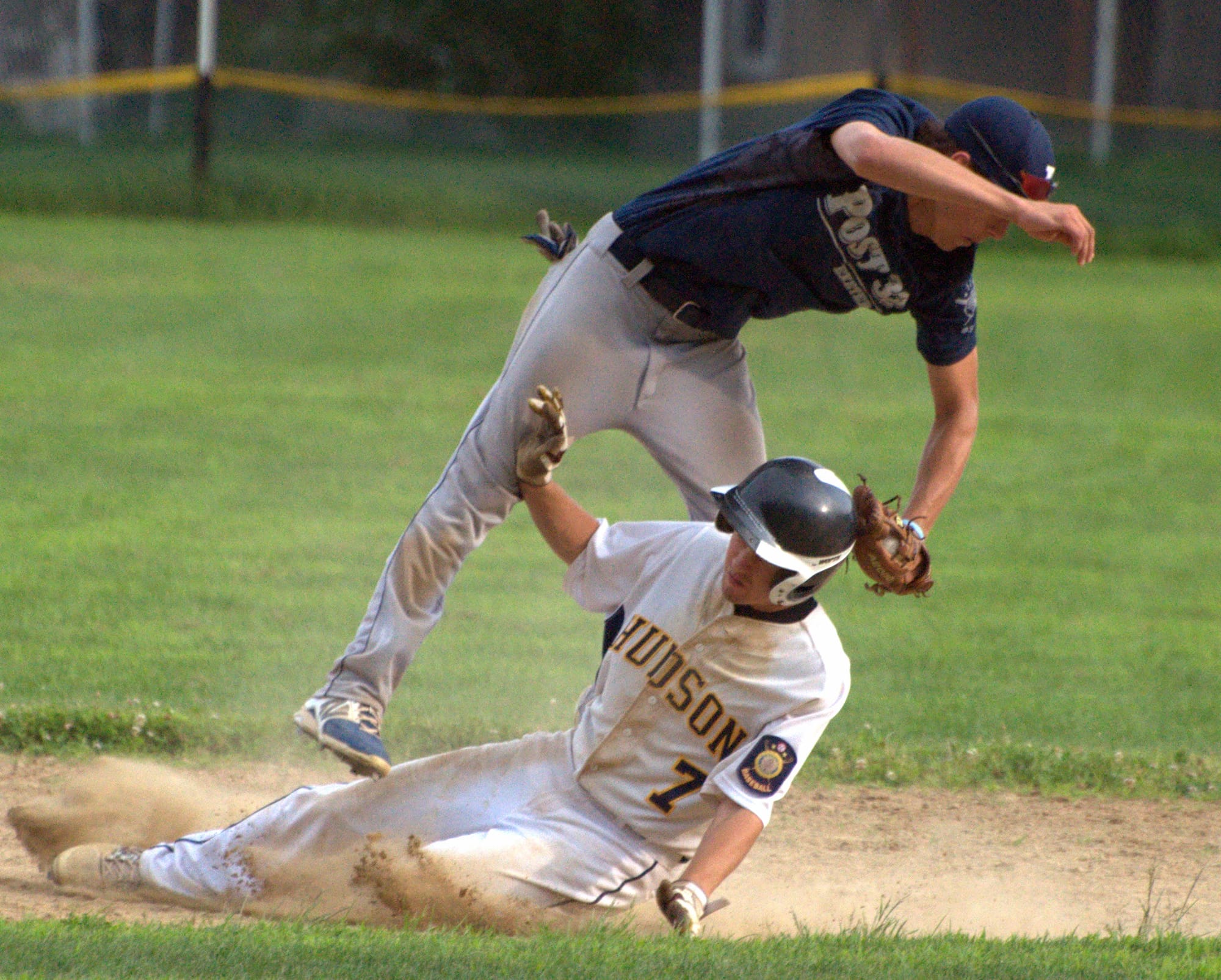 Exeter's Kyle Ball makes the tag as he gets upended by Hudson's Pat Rauseo during Wednesday's game.