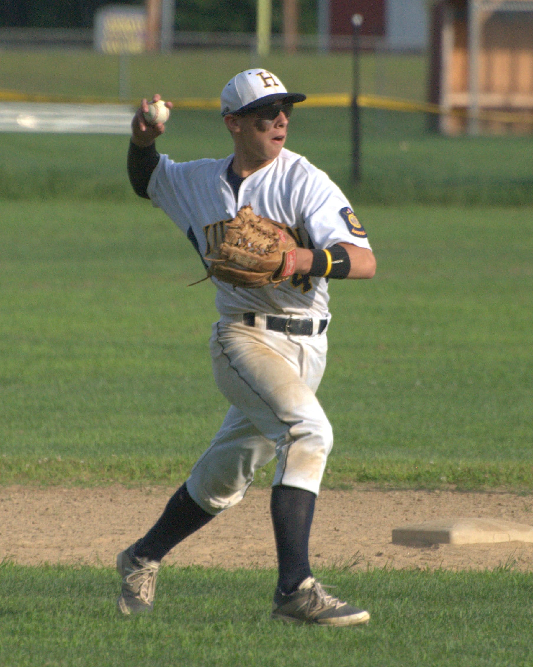 Hudson's Matt Gagne makes a throw to first.