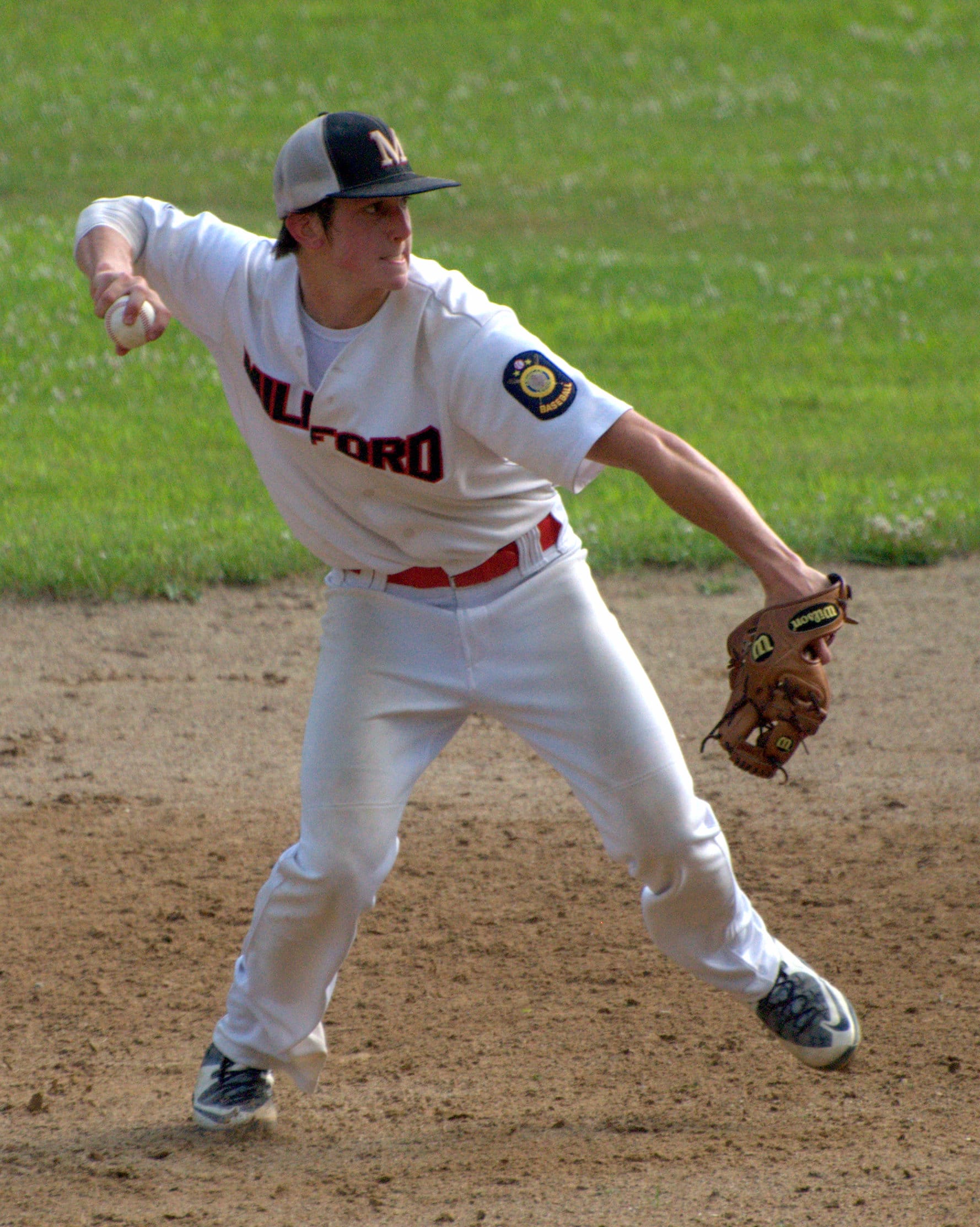 Milford's Tommy Bennett makes a throw to first.