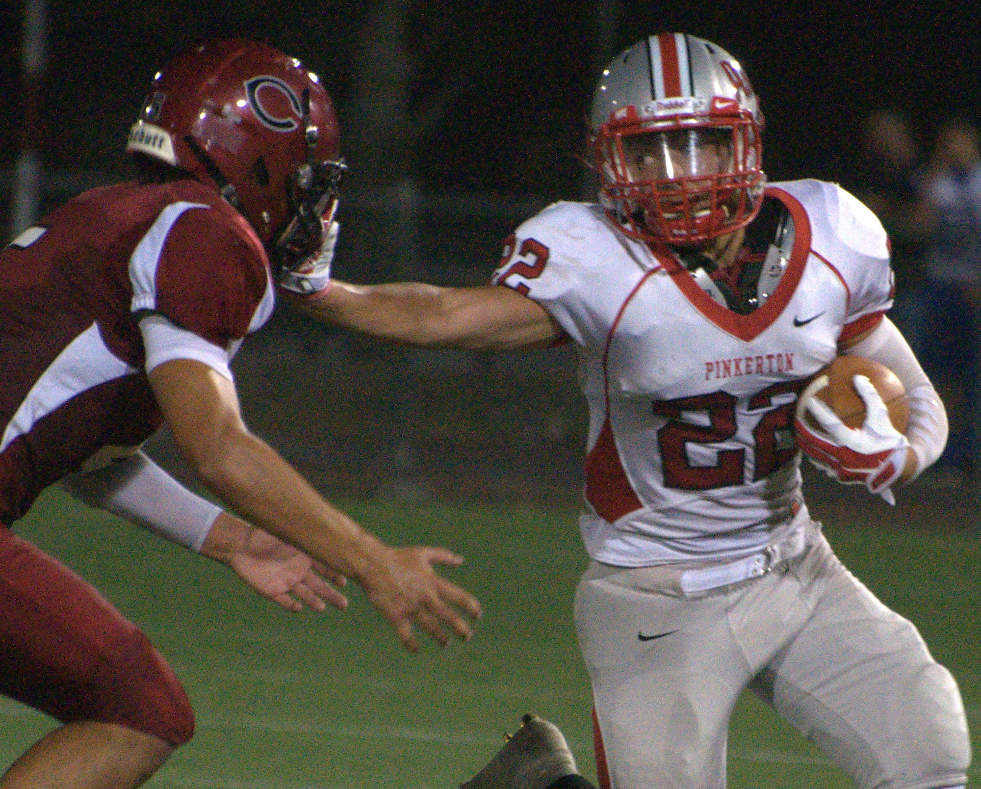 Pinkerton's Nick Coombs stiff arms Concord's Matt Burke.