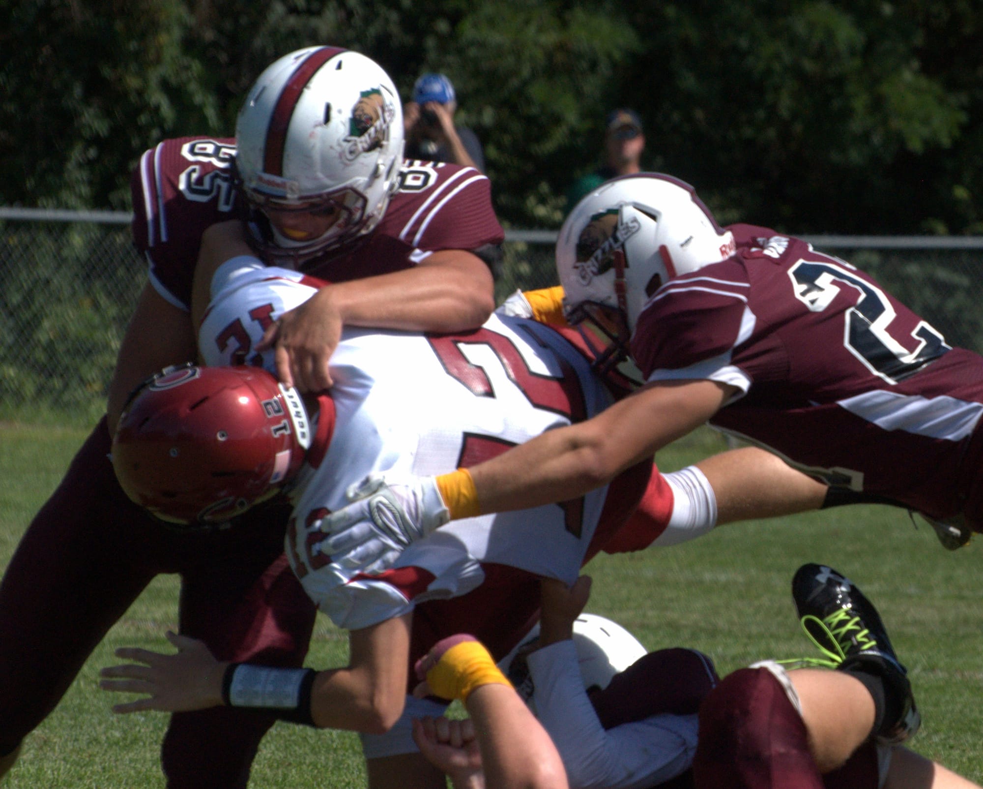 Goffstown's Tim Comeau, left, and Damian Jackson team up on a sack of Concord's Jake Lewis.