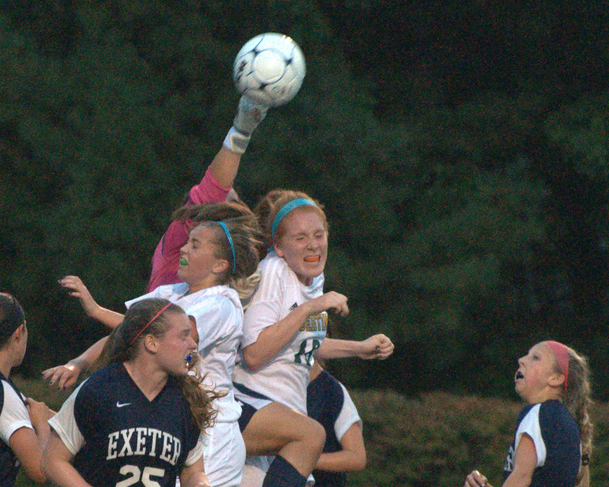 Exeter goalie Julia Wilson gets a hand on a corner kick before Bishop Guertin's Kiley Deignan, right, can get to it during Tuesday's game.