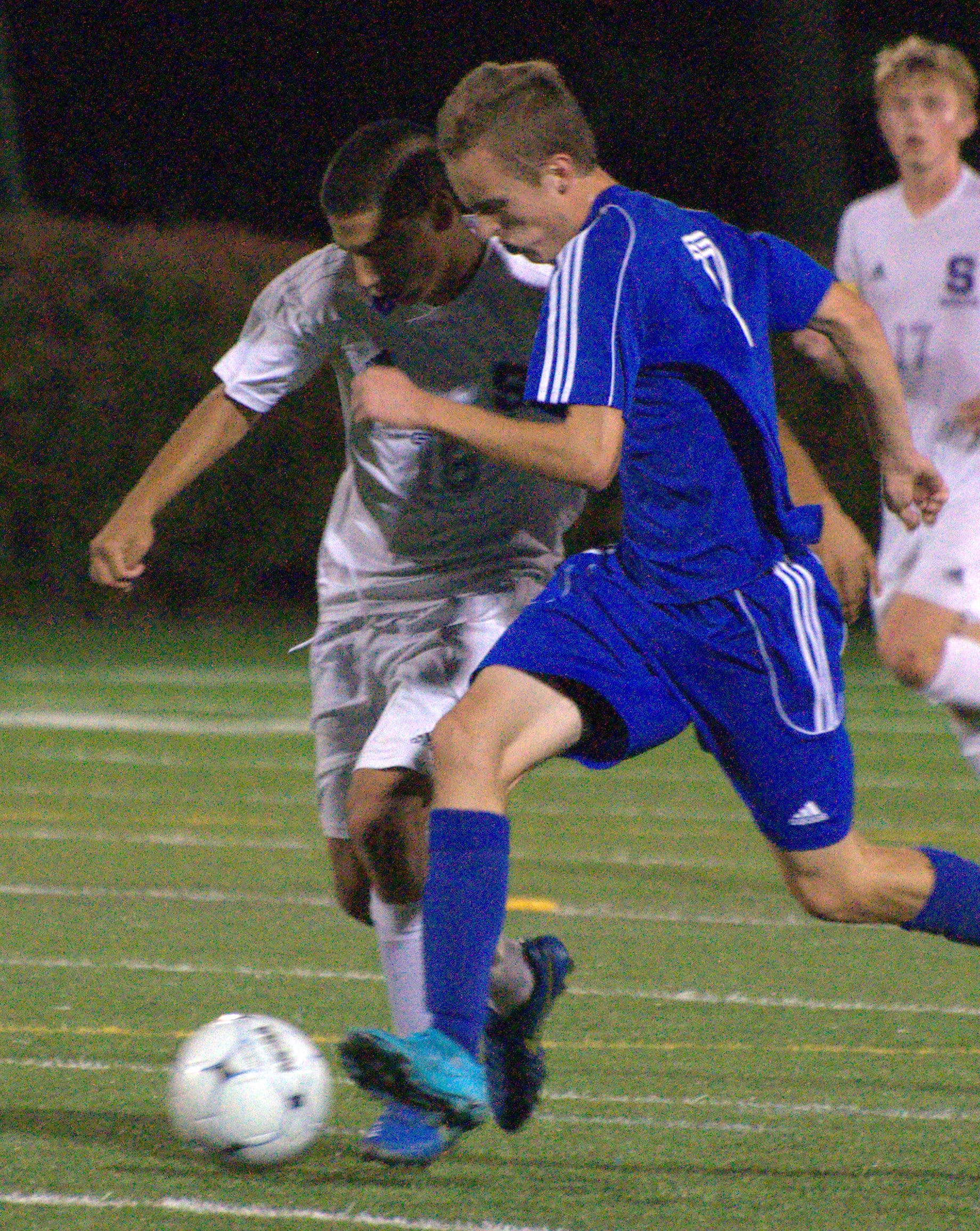 Nashua South's Mauricio Acevedo and Merrimack's Noah Avery chase after the ball.