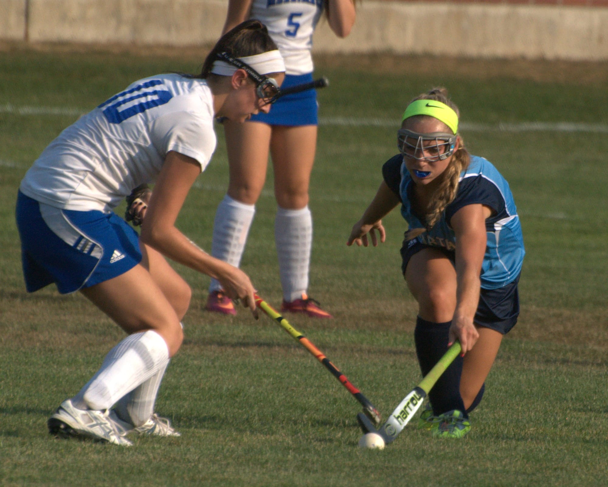 Nashua North's Gabby Masseaur tries to knock the ball away from Merrimack's Jess Londono.