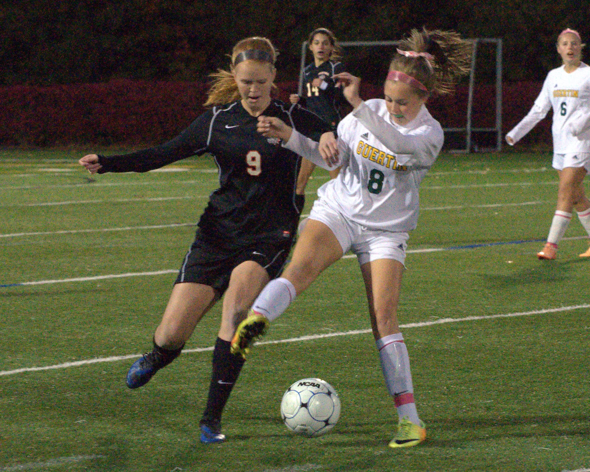 Bedford's Torie Trompak and Bishop Guertin's Maddison Gilbride battle for the ball.