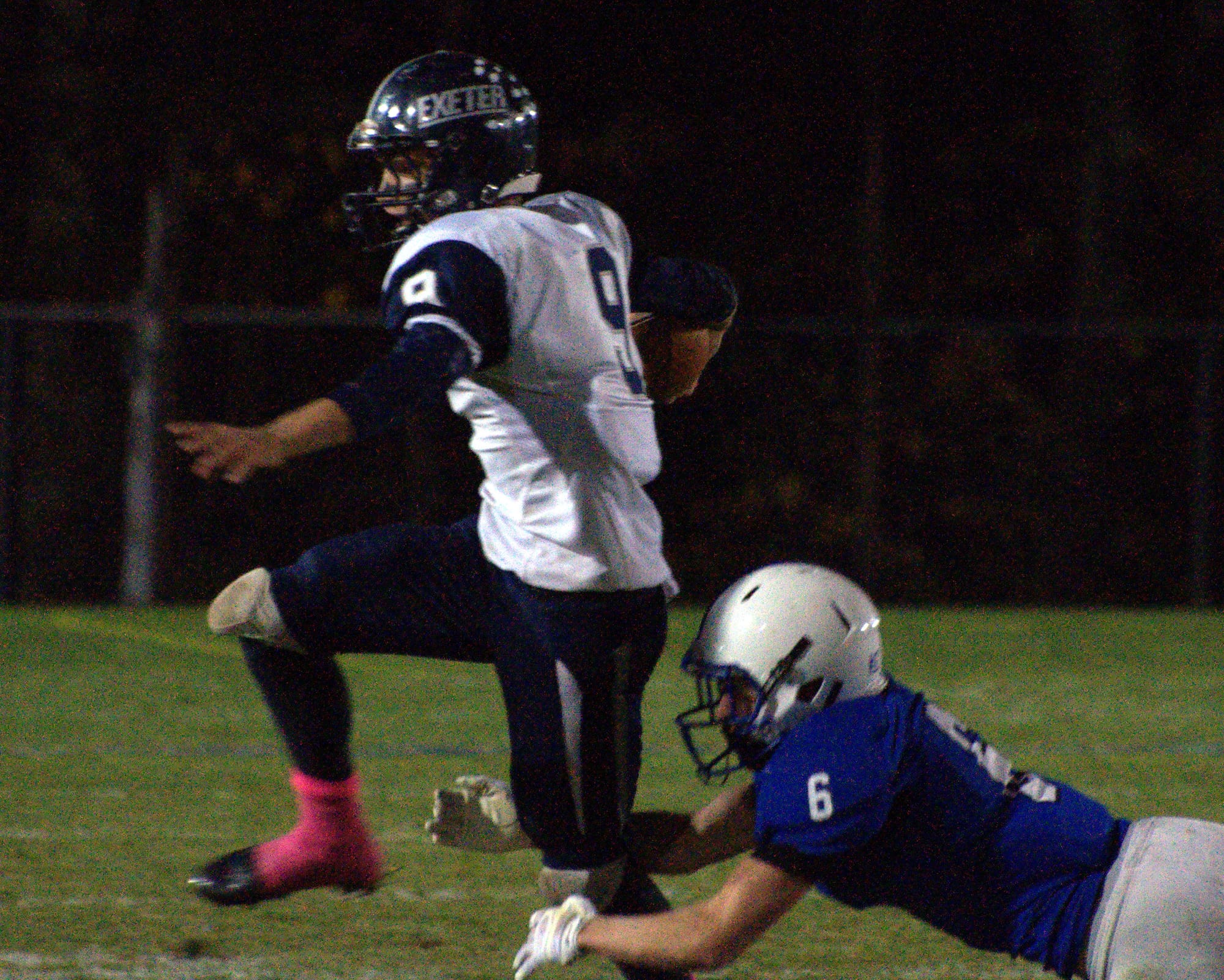 Merrimack's Ryan Fournier tries to trip up Exeter's Kyle Ball.