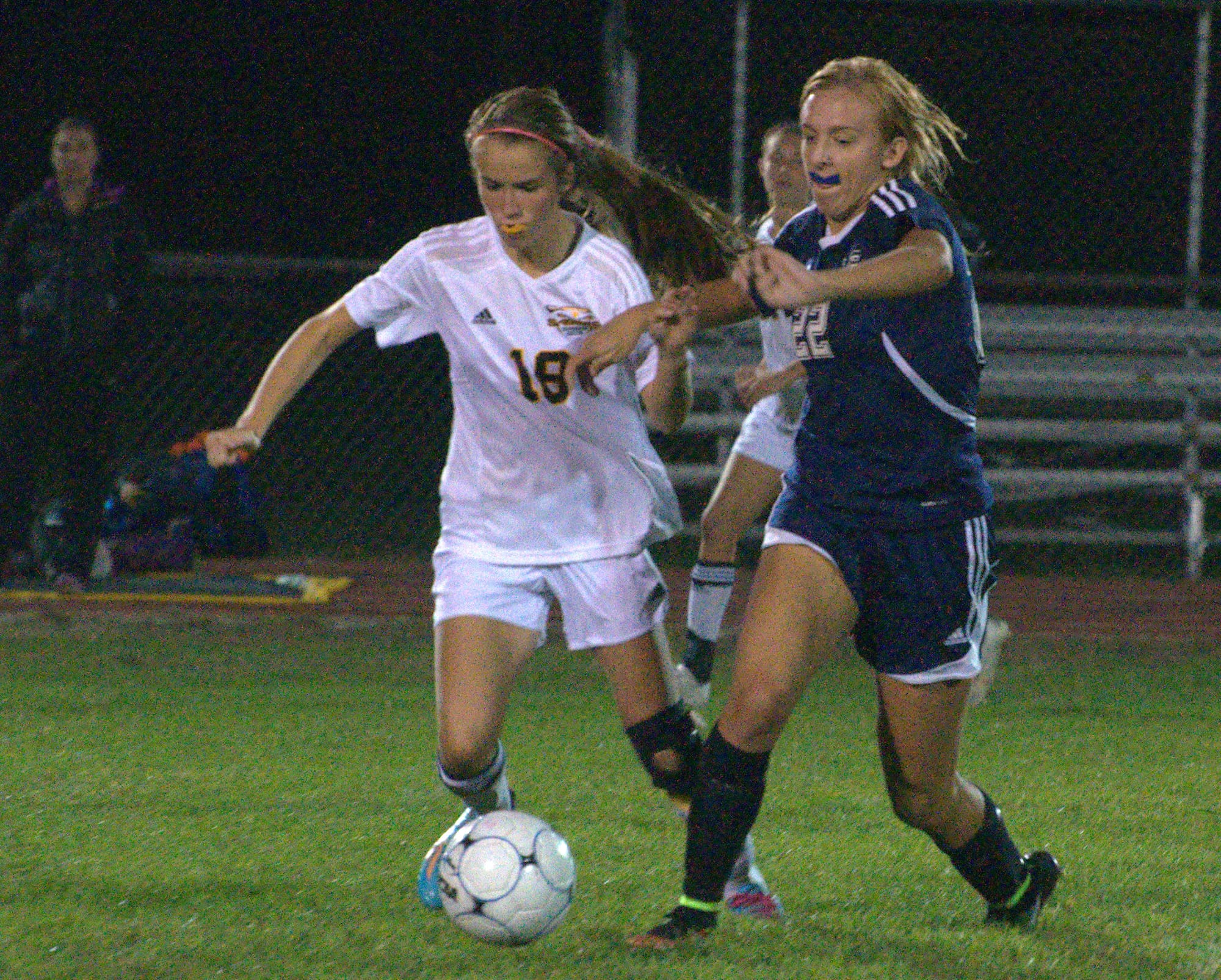 Souhegan's Alan Barreto and Hollis Brookline's Sydney Brackett go after the ball.