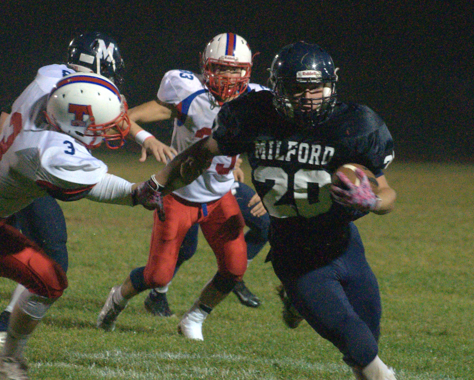 Milford's Mark Madigan gets away from Trinity's Colin Hines during Friday's game.