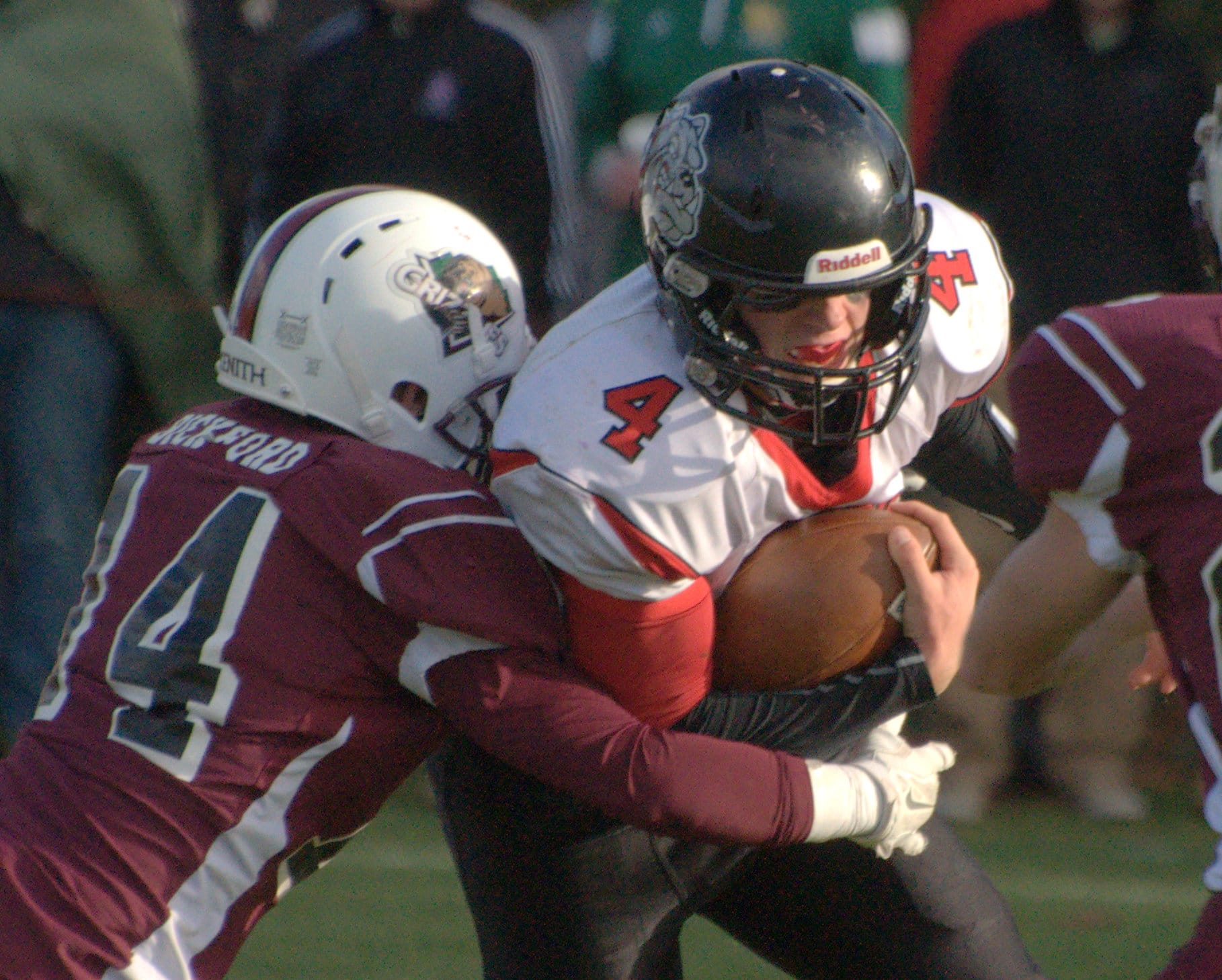 Bedford's Connor Robert tries to fight off Goffstown's Peyton Bickford.
