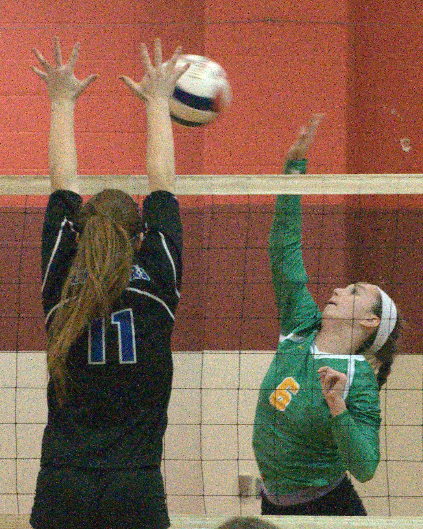 Bishop Guertin's Lexie Cambray tries to hit around Hollis Brookline's Sophie Saunders.