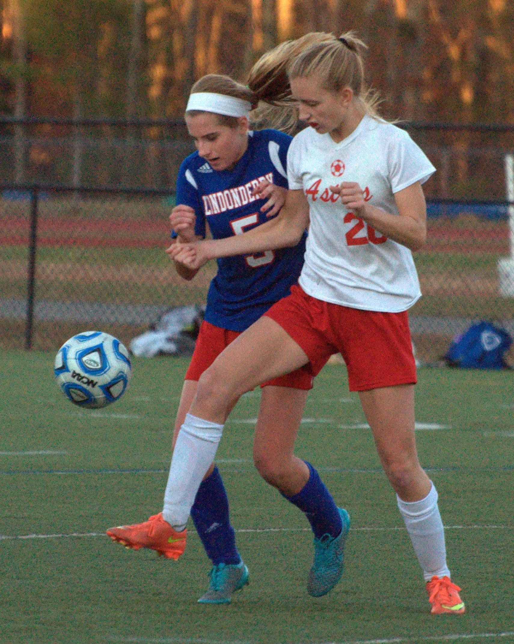 Pinkerton's Courtney Velho and Londonderry's Laurel Goding battle for the ball.