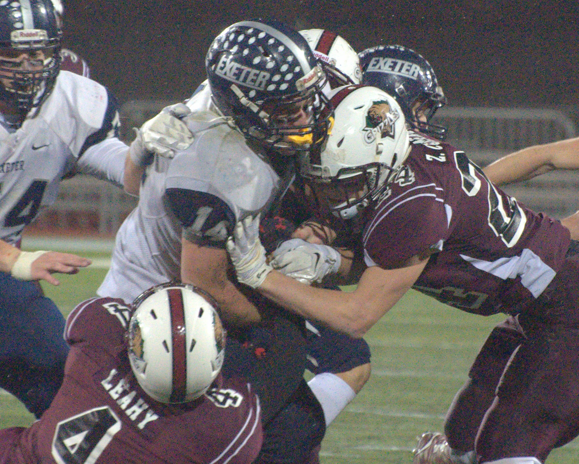 Goffstown's Pat Leahy (No. 4) and Zach Comeau wrapup Exeter's Jackson Allen.