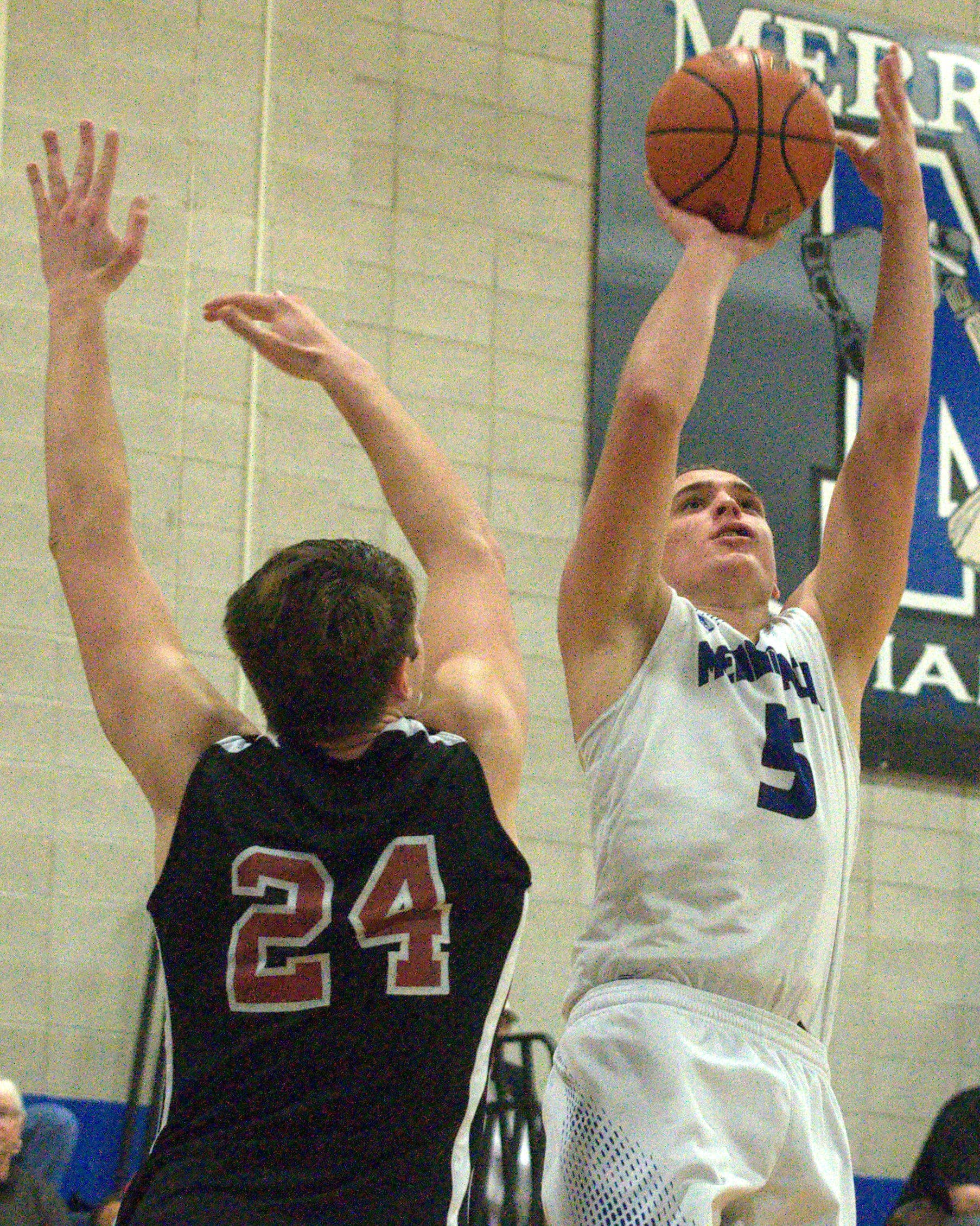 Merrimack's Ian Roberts puts up a shot as Bedford's Colby Gendron defends.
