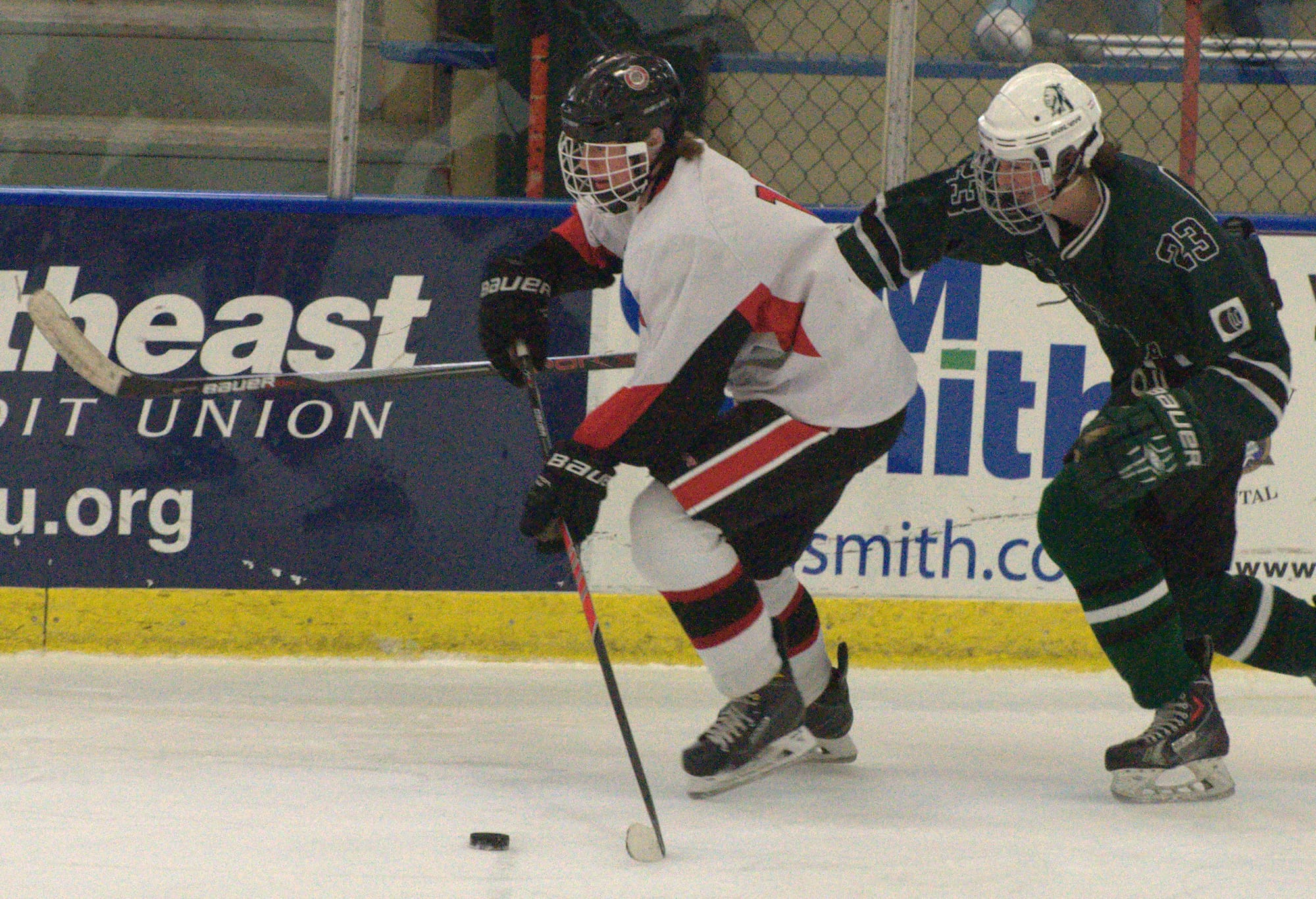 Bedford's Jay Roberto skates away from Manchester Central's Stephan Langley.