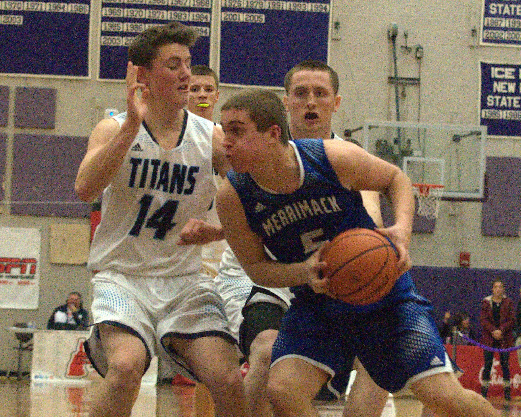 Merrimack's Ian Roberts drives to the basket as Nashua North's Michael Lentz defends.