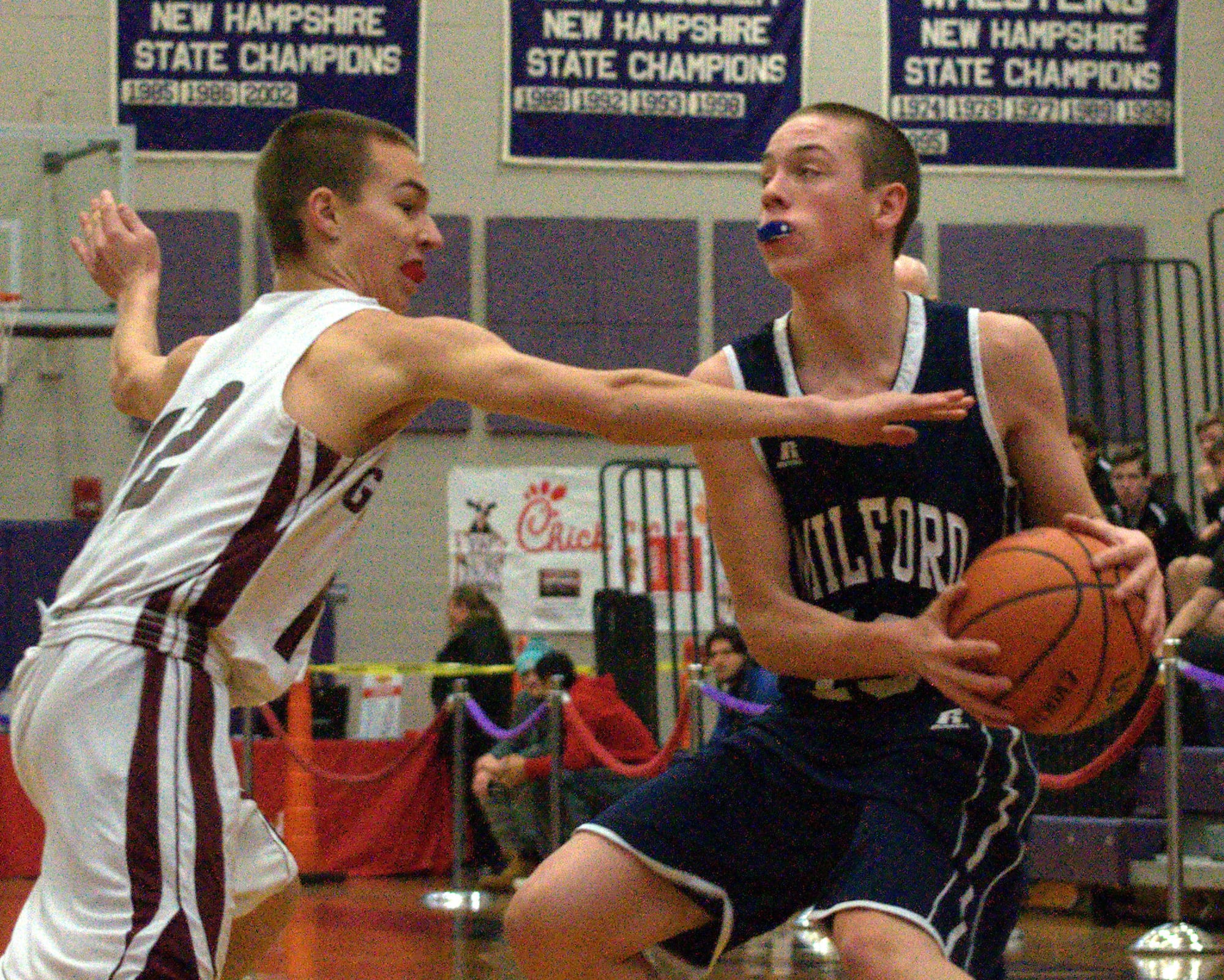 Goffstown's Jacob Borges tries to knock the ball away from Milford's Ryan Banuskevich.