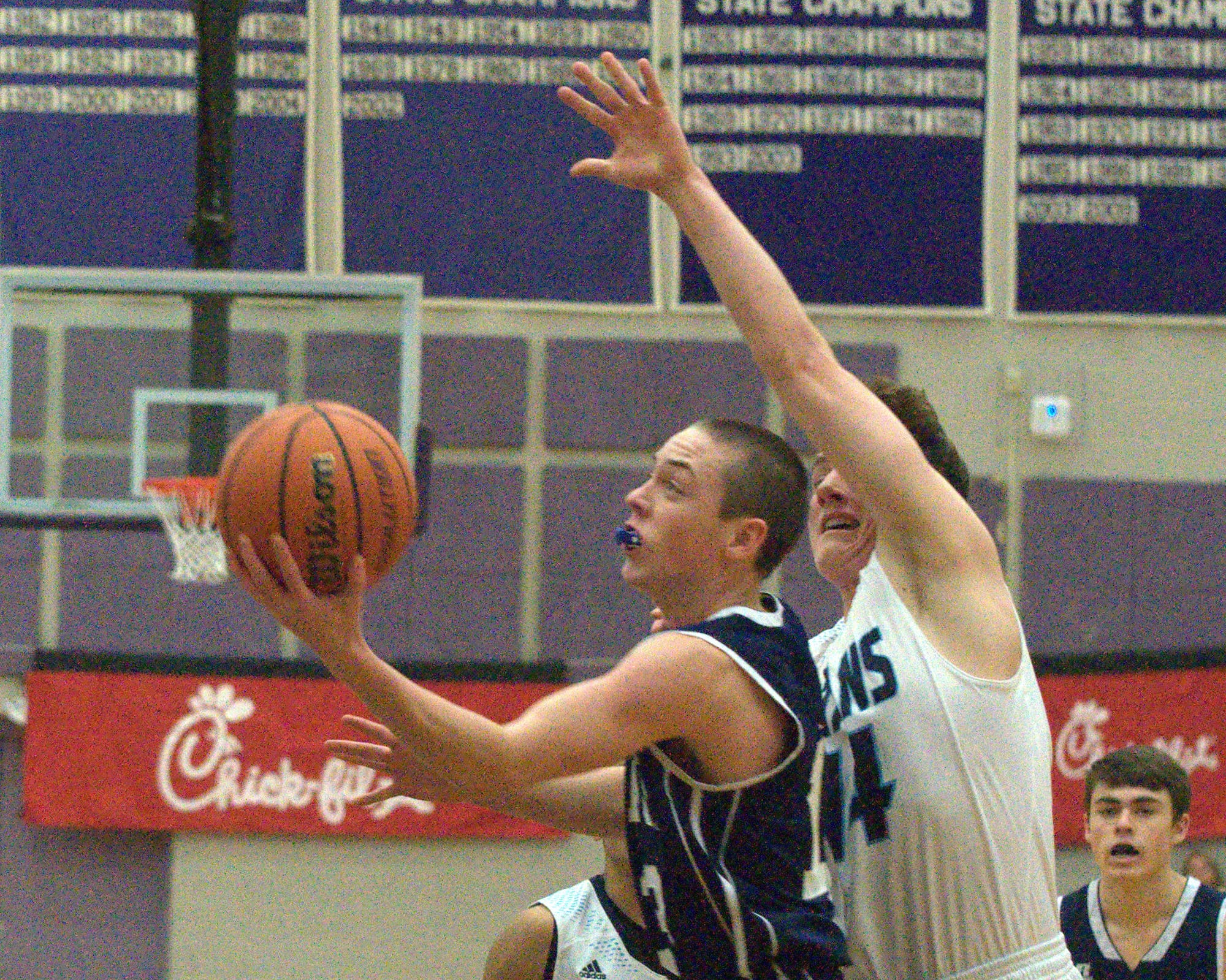 Milford's Ryan Banuskevich drives past Nashua North's Michael Lentz.
