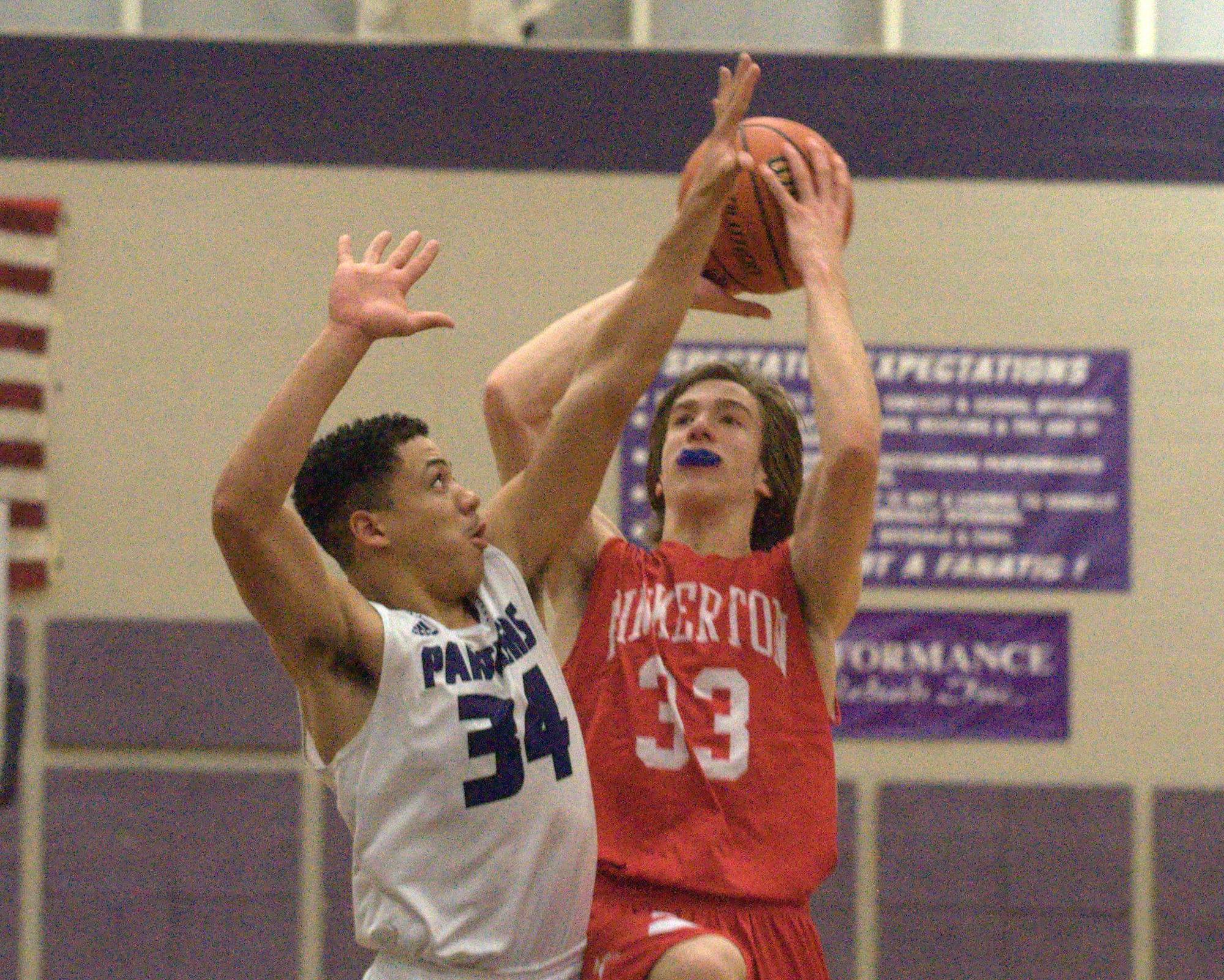 Pinkerton's Brennan Morris takes a shot over Nashua South's Zavier Williams. For more photos, go to the Photo Album.