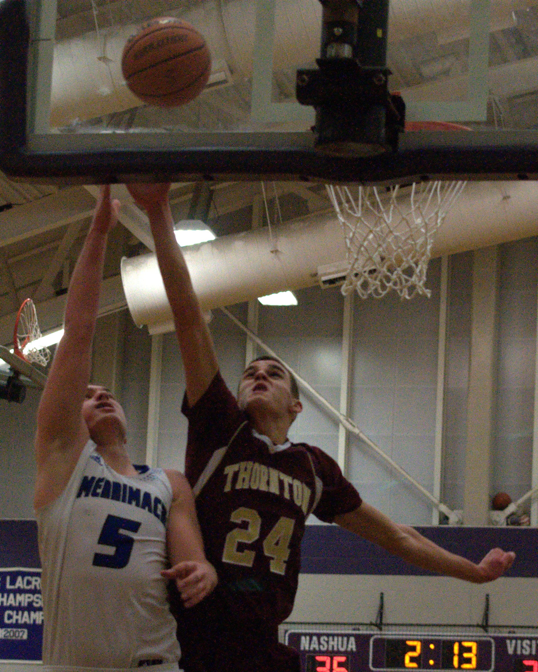 Thornton's John Fogg tries to block a shot by Merrimack's Ian Roberts.