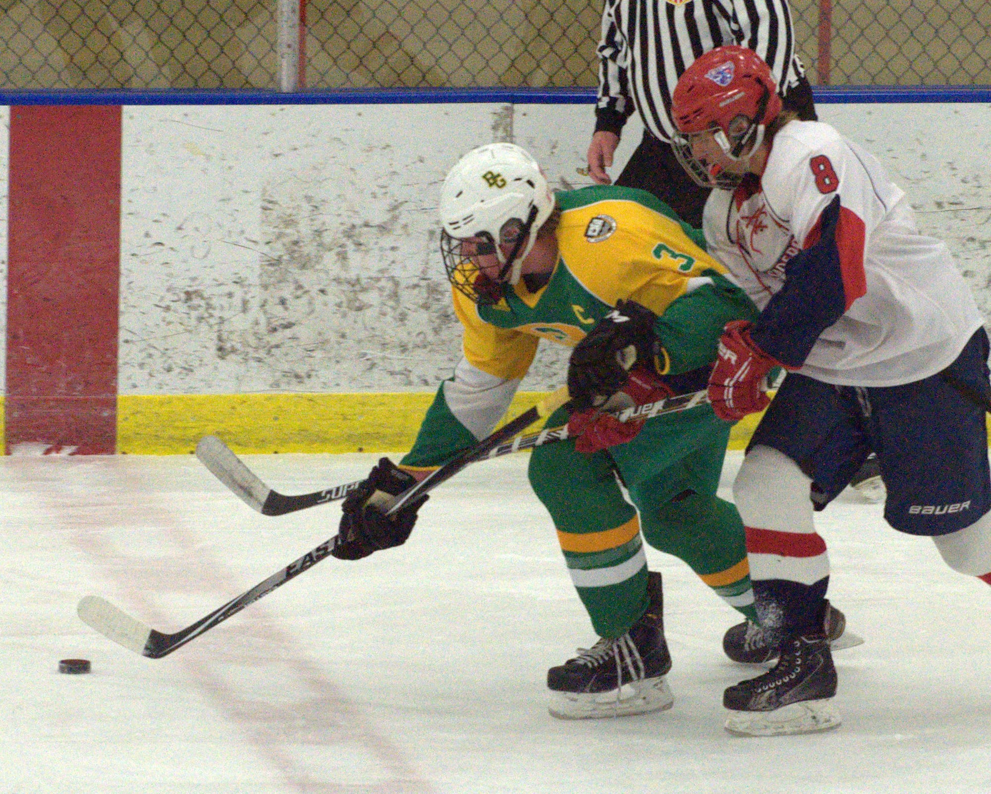Manchester Memorial's Jacob Poitras tries to slow down Bishop Guertin's Cam Hult.