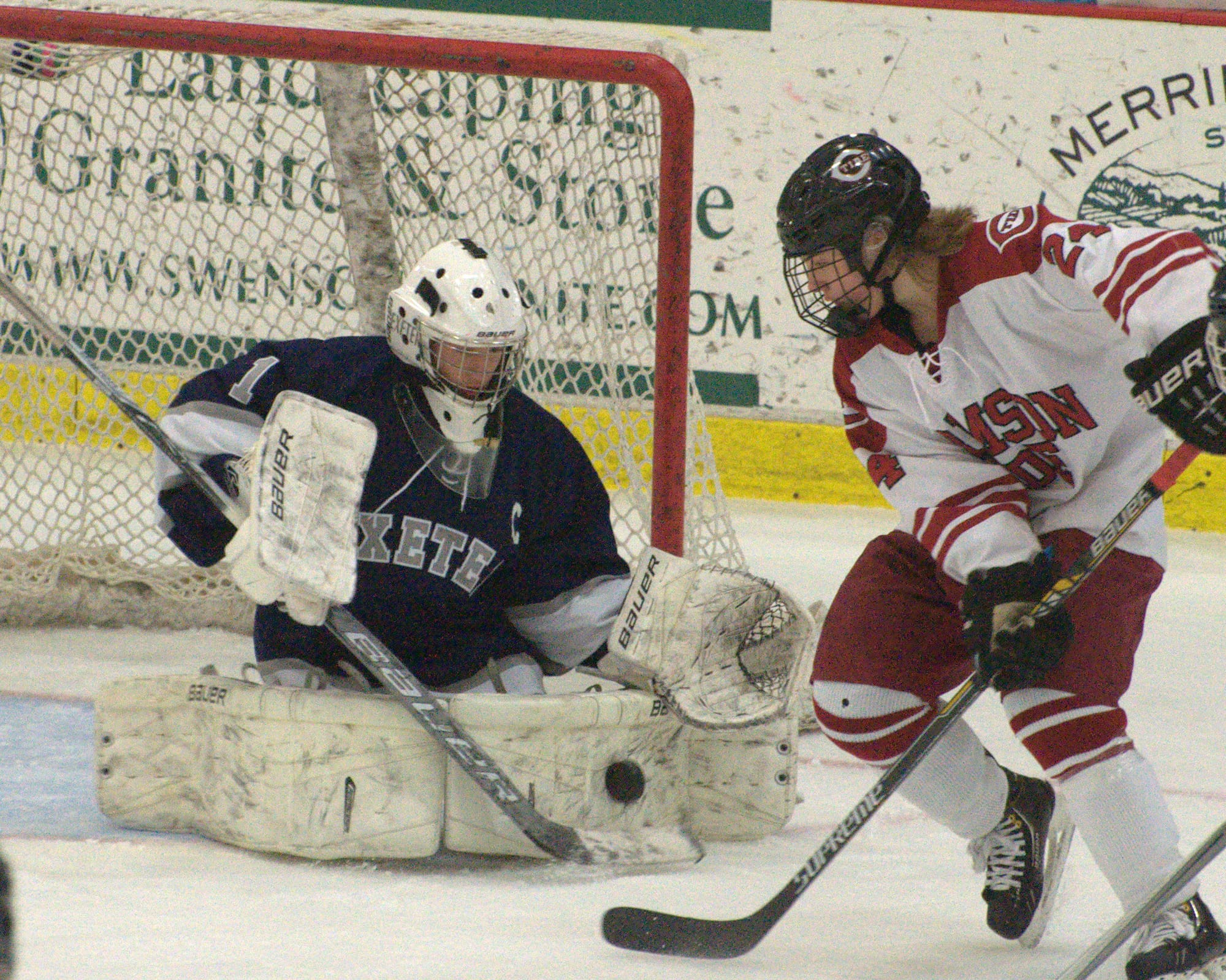 Concord's Colin Kastle tries to redirect a shot by Exeter's Bryson Desjardins.