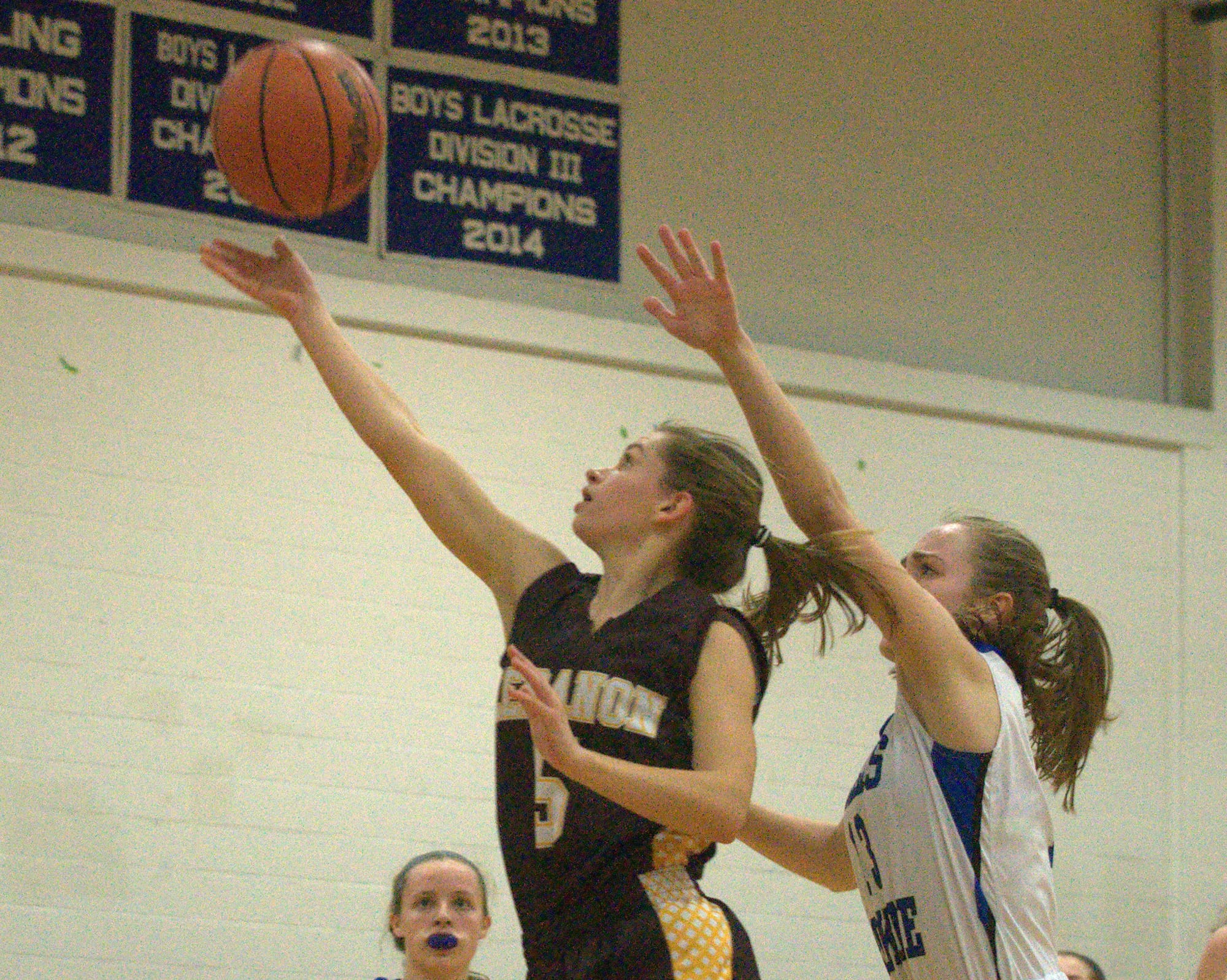 Lebanon's Meredith Melendy takes a shot as Hollis Brookline's Brodie Kelley defends.
