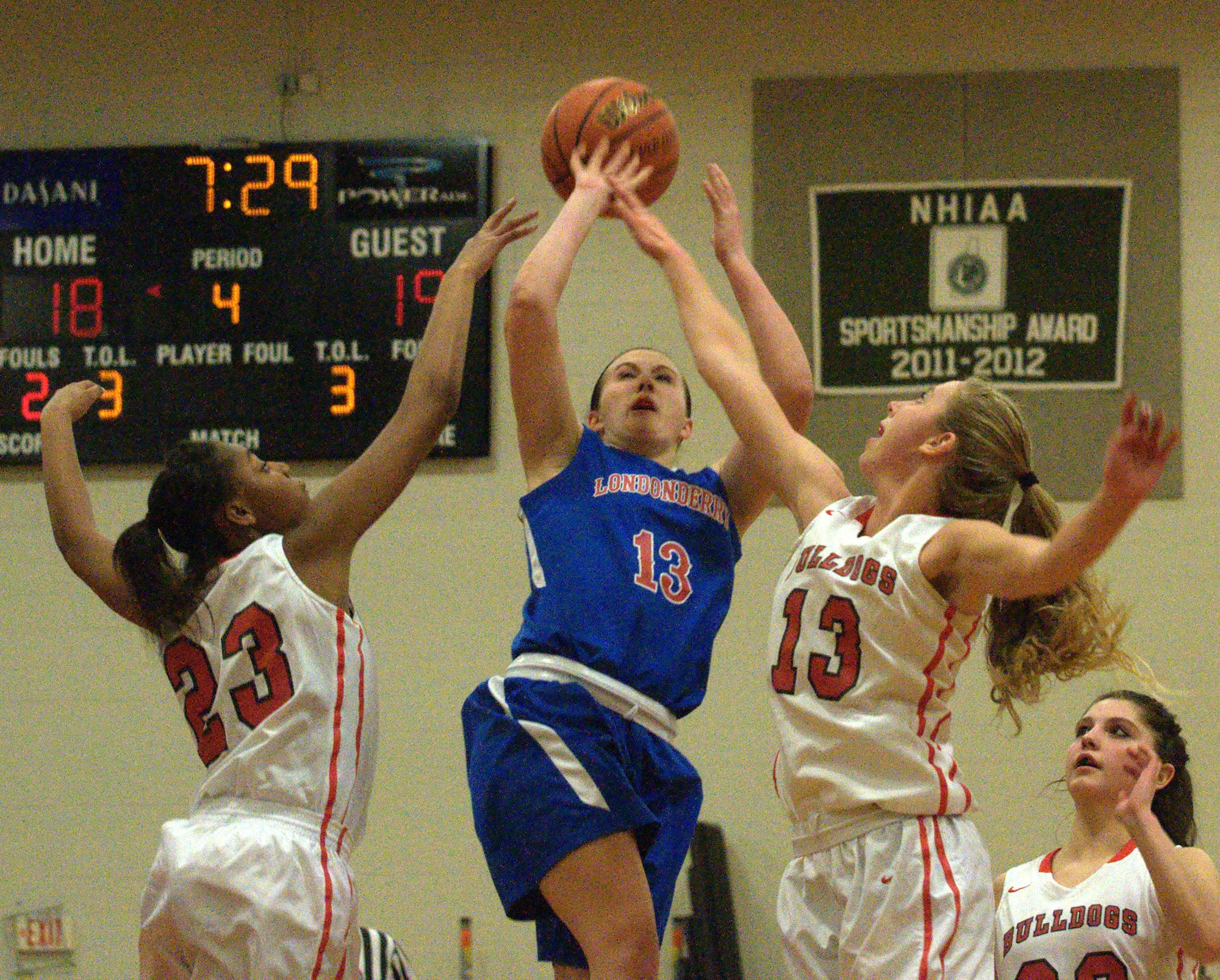 Londonderry's Jaclyn Luckhardt tries to get a shot off as Bedford's Jenoyce Laniyan, left, and Courtney O'Connell defend.