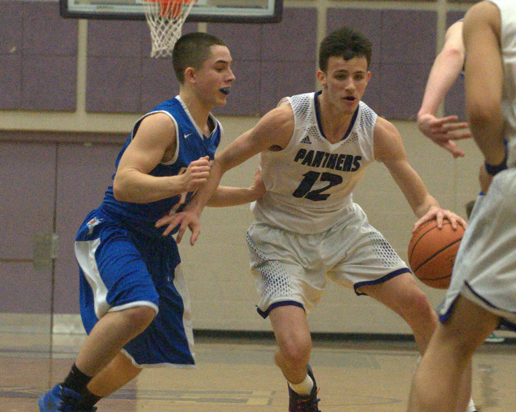 Nashua South's DJ Frechette handles the ball as Londonderry's Cole Britting defends.